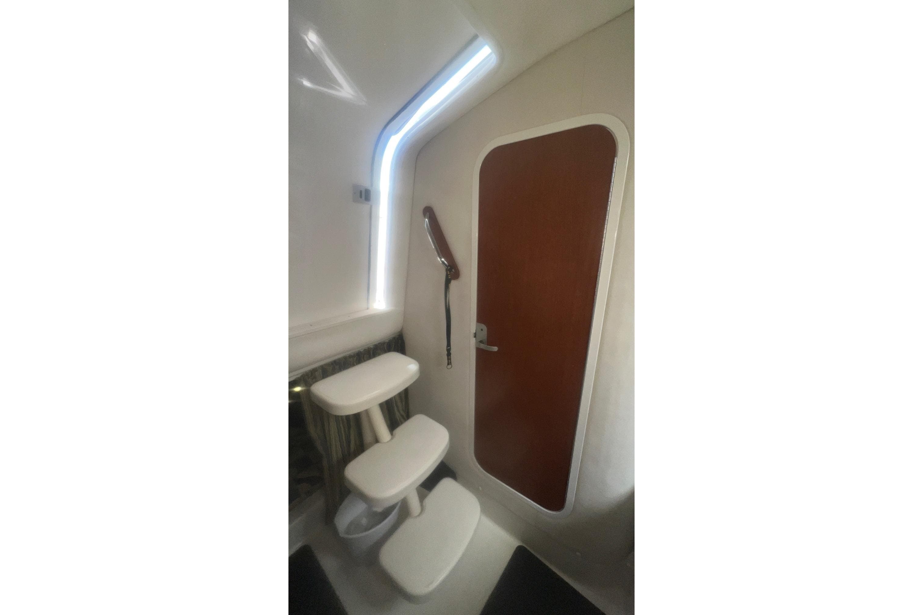 Interior of 2008 Pro-Line 32 Express boat with steps and wooden door.