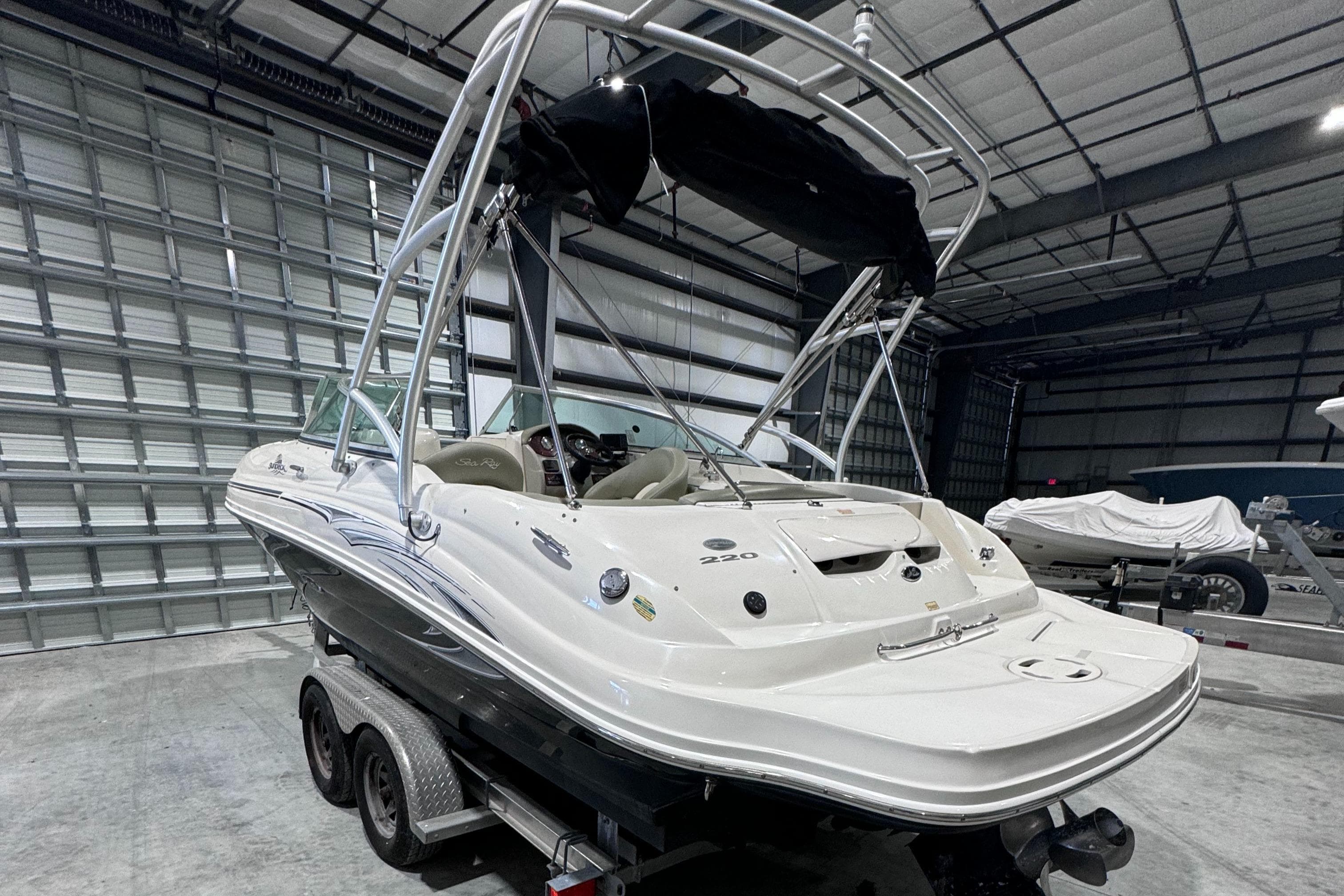 2005 Sea Ray 220 Sundeck boat on trailer in storage facility.