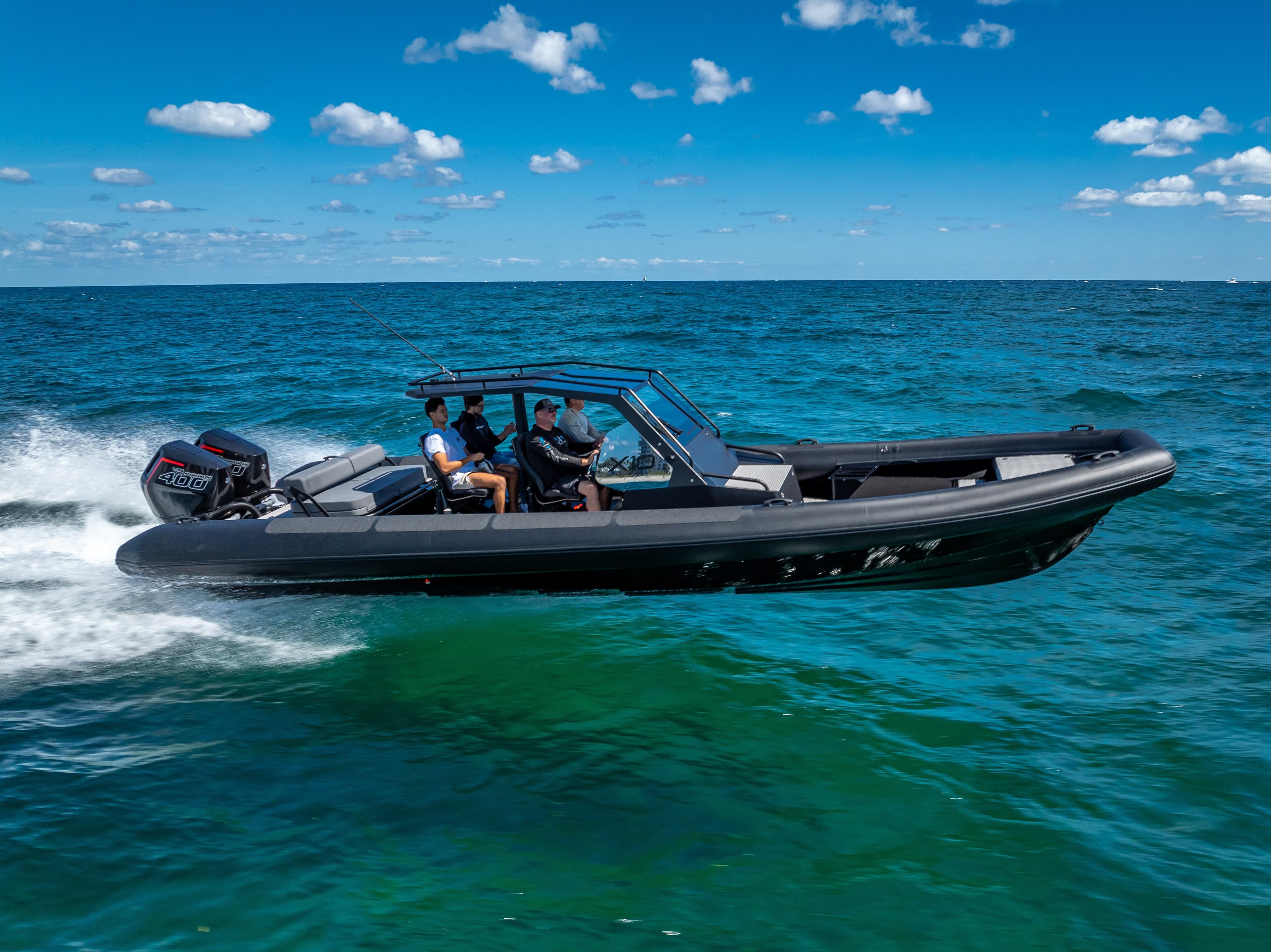 2024 Goldfish X10 Scout boat cruising on open water under a clear blue sky.