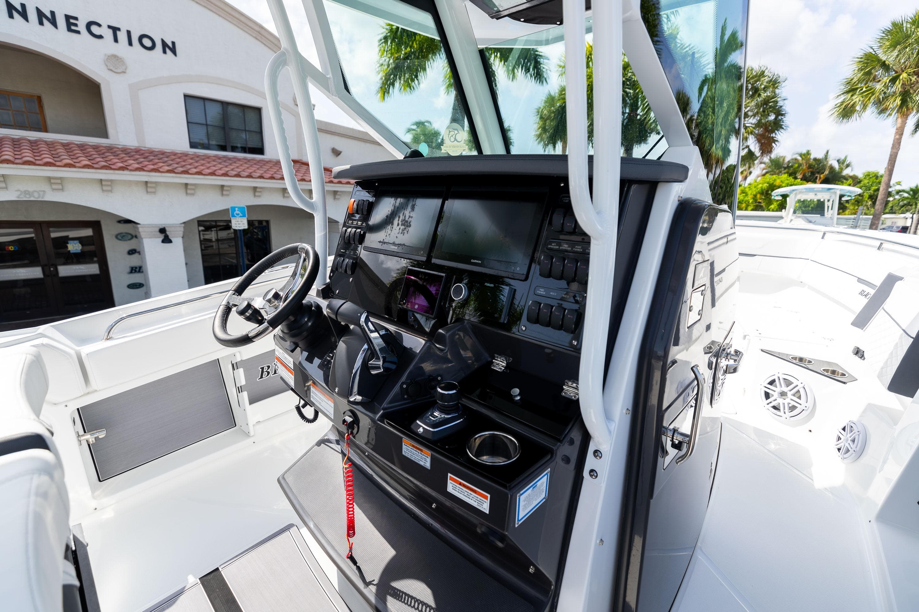 2023 Blackfin 302CC boat cockpit with modern controls and steering wheel.