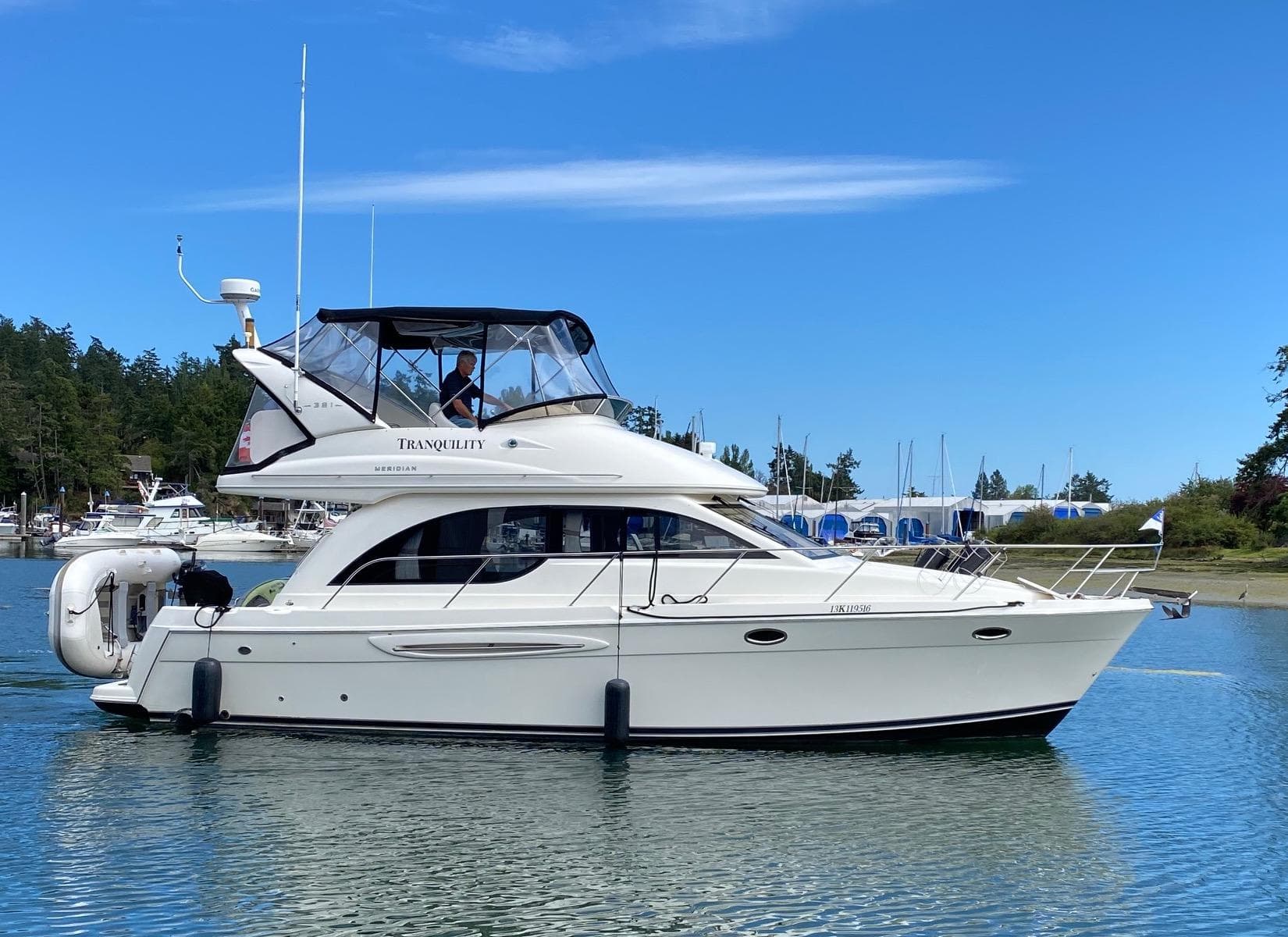2006 Meridian 381 Sedan on calm water, blue sky.