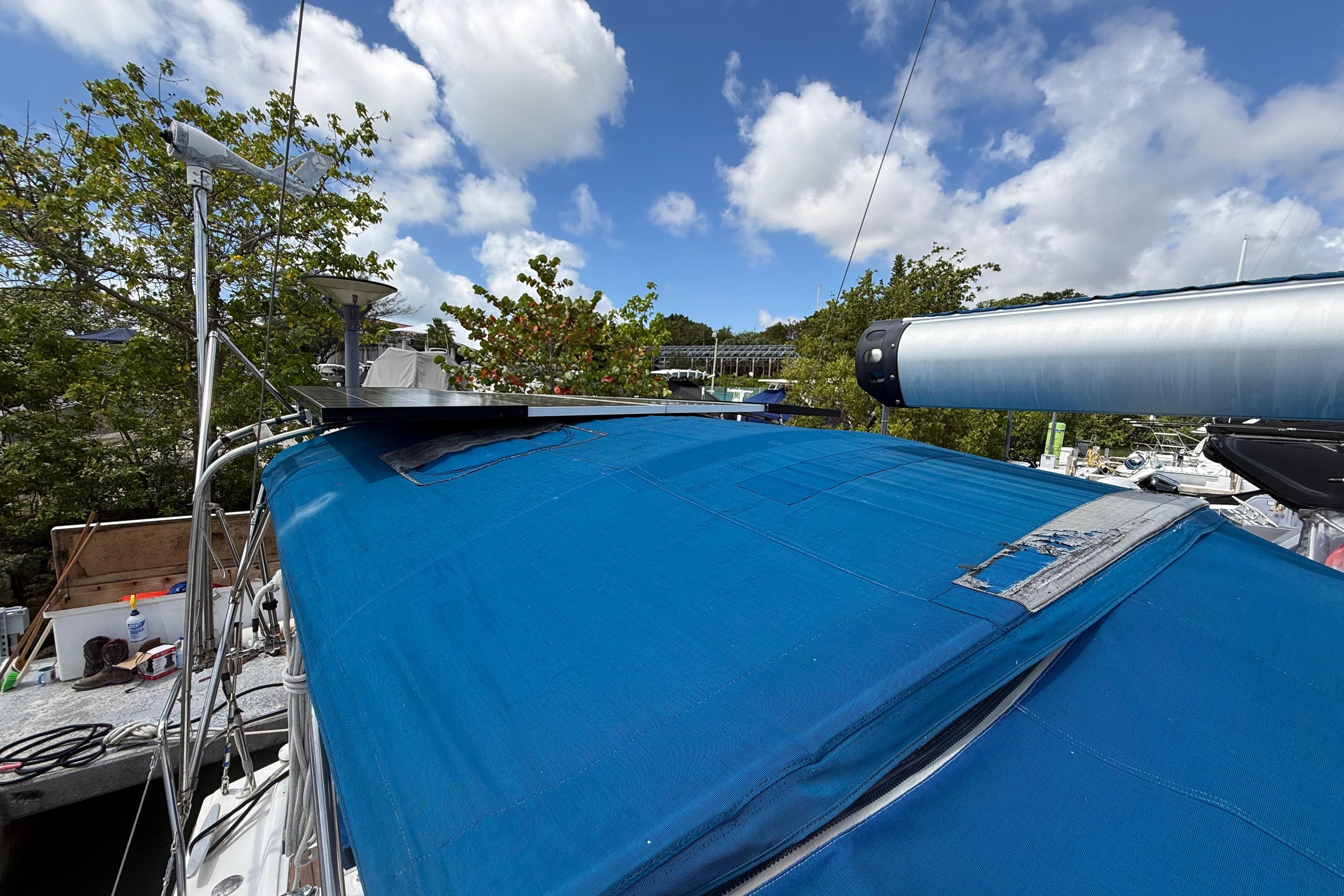 Beneteau Oceanis 40 sailboat, 2009 model, with blue cover and clear sky background.