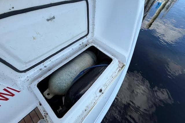Storage compartment on a 2005 Hunter 38 boat, containing a propane tank.