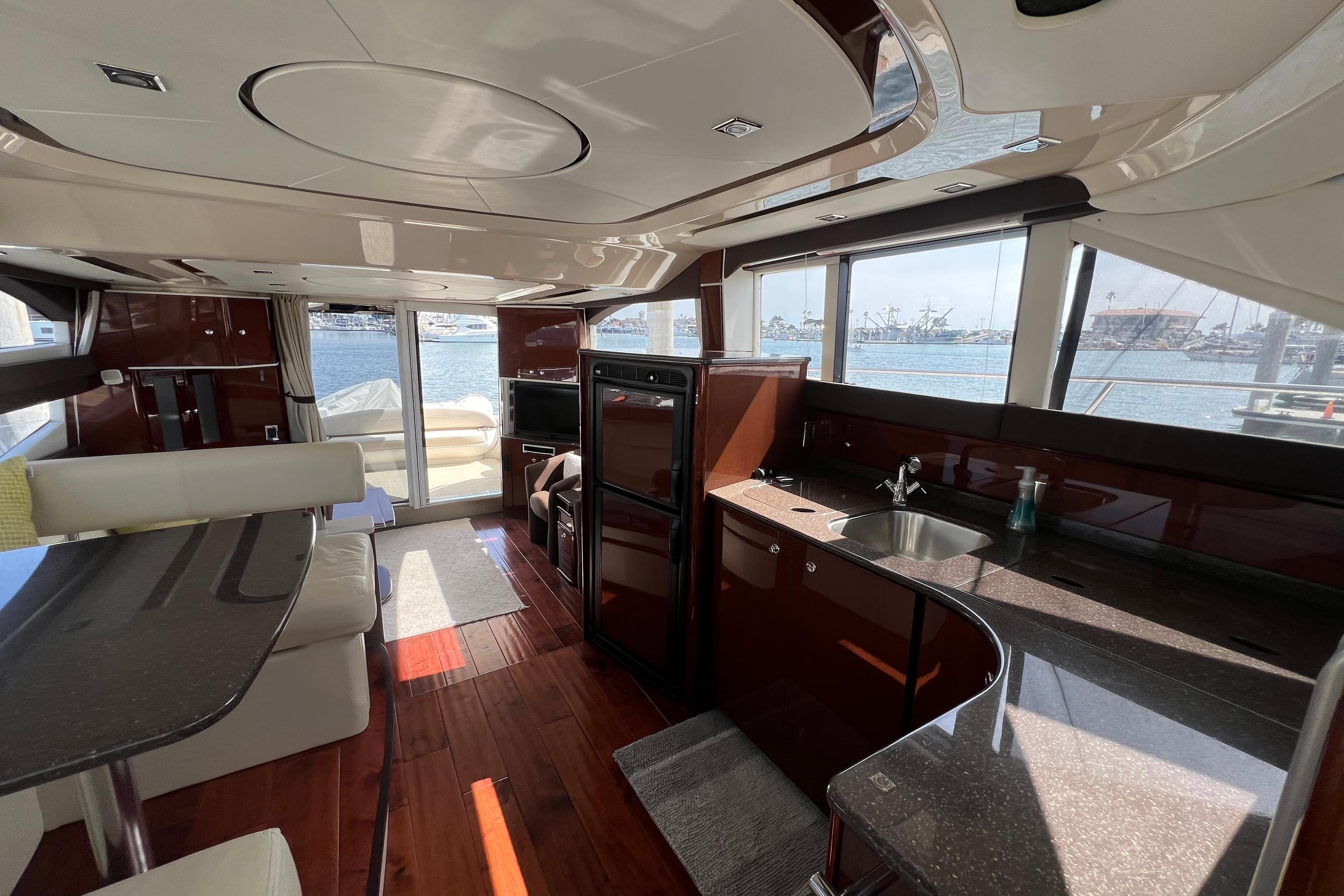 Luxurious interior of 2013 Meridian 441 Sedan yacht with modern kitchen and scenic windows.