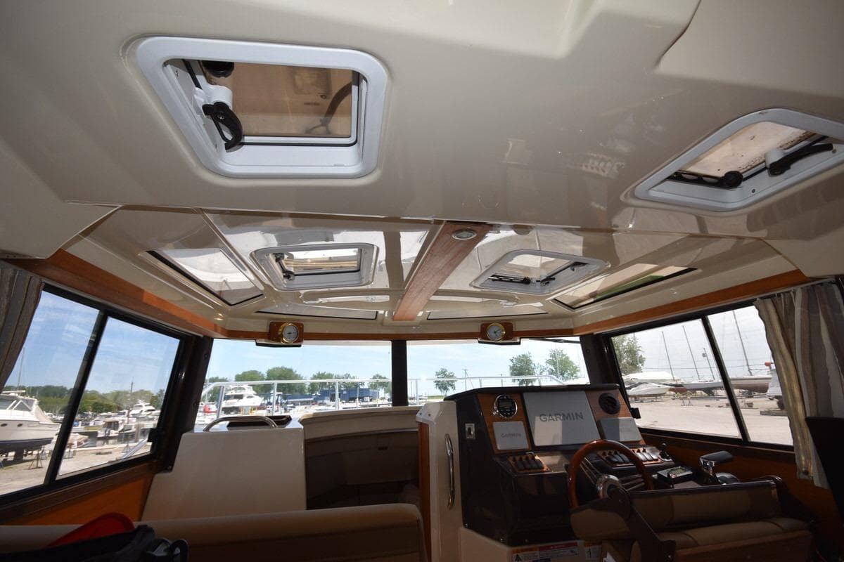 2024 Ranger Tugs R-25 interior cabin with skylights and navigation equipment.