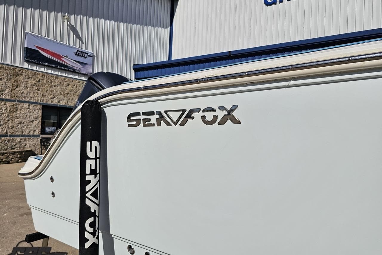 2013 Sea Fox 286 Commander boat exterior with logo, displayed at a dealership.