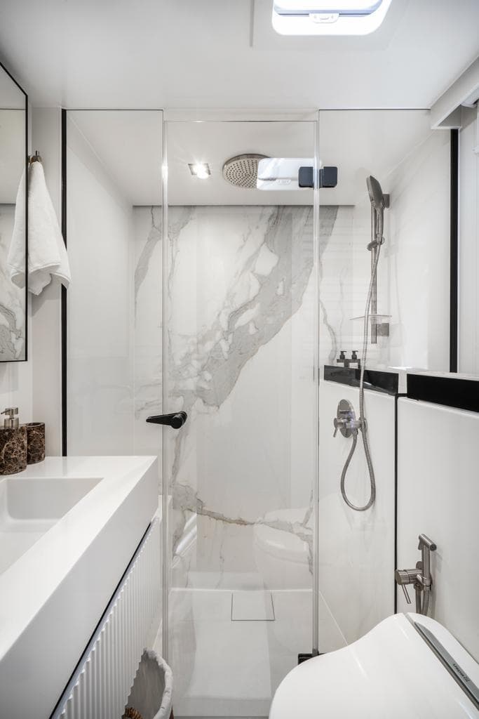 Luxurious bathroom in 2022 Sunreef 70 Sailing yacht with modern shower and sleek design.
