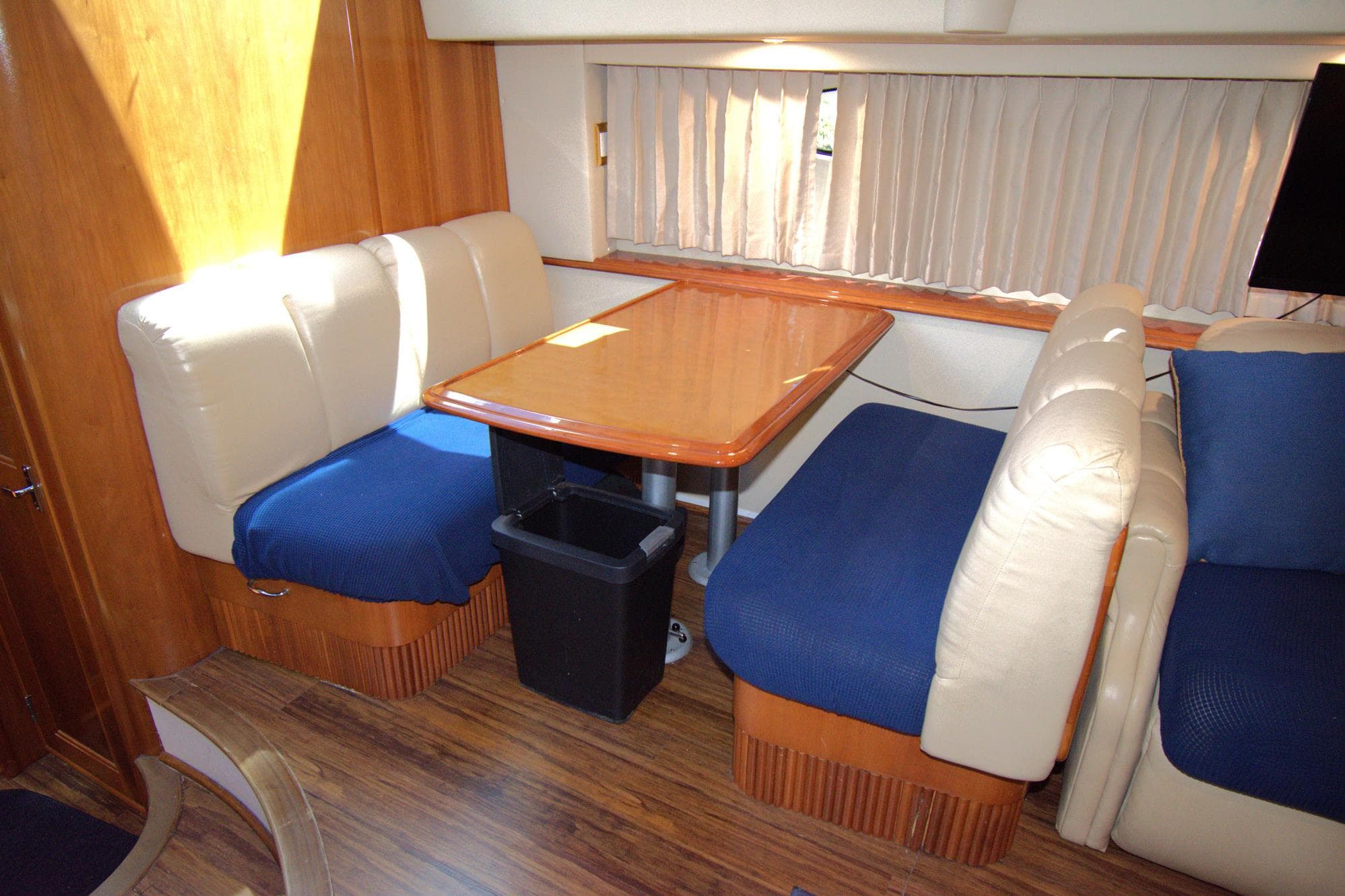 Interior of 2005 Carver 444 Cockpit Motor Yacht with dining area and seating.