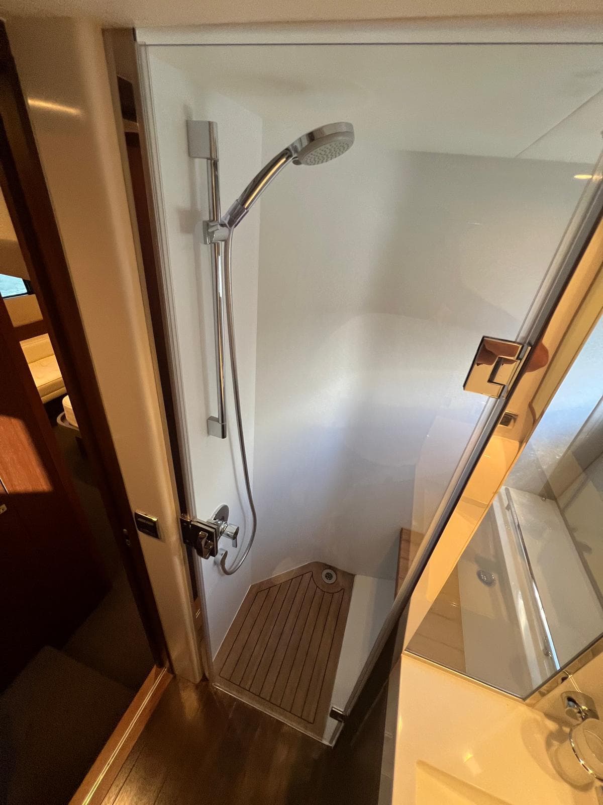 Shower area in 2011 Princess V62 yacht with wooden flooring and modern fixtures.