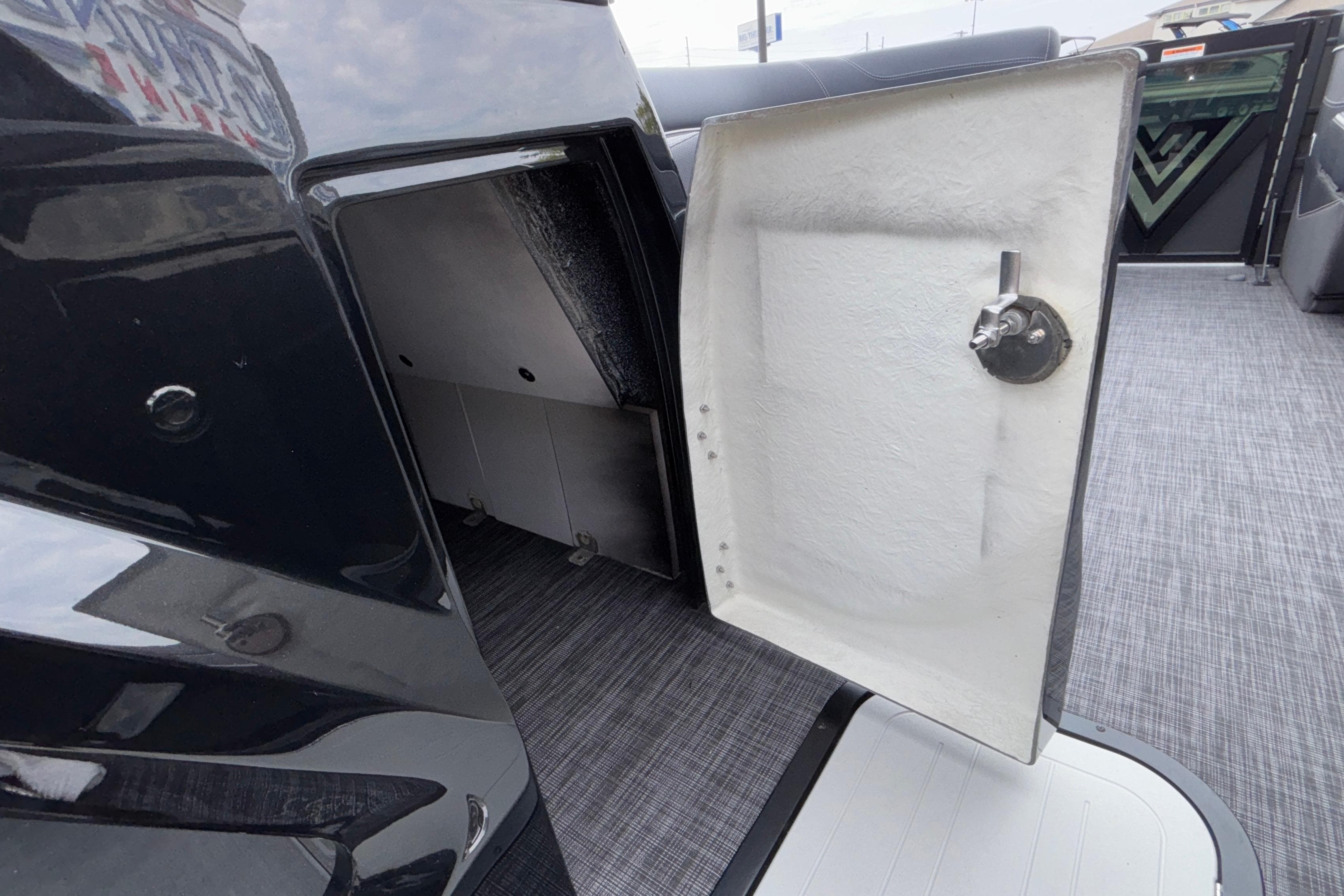 Open storage compartment on 2026 Viaggio D28UW A-T boat, featuring sleek interior design.