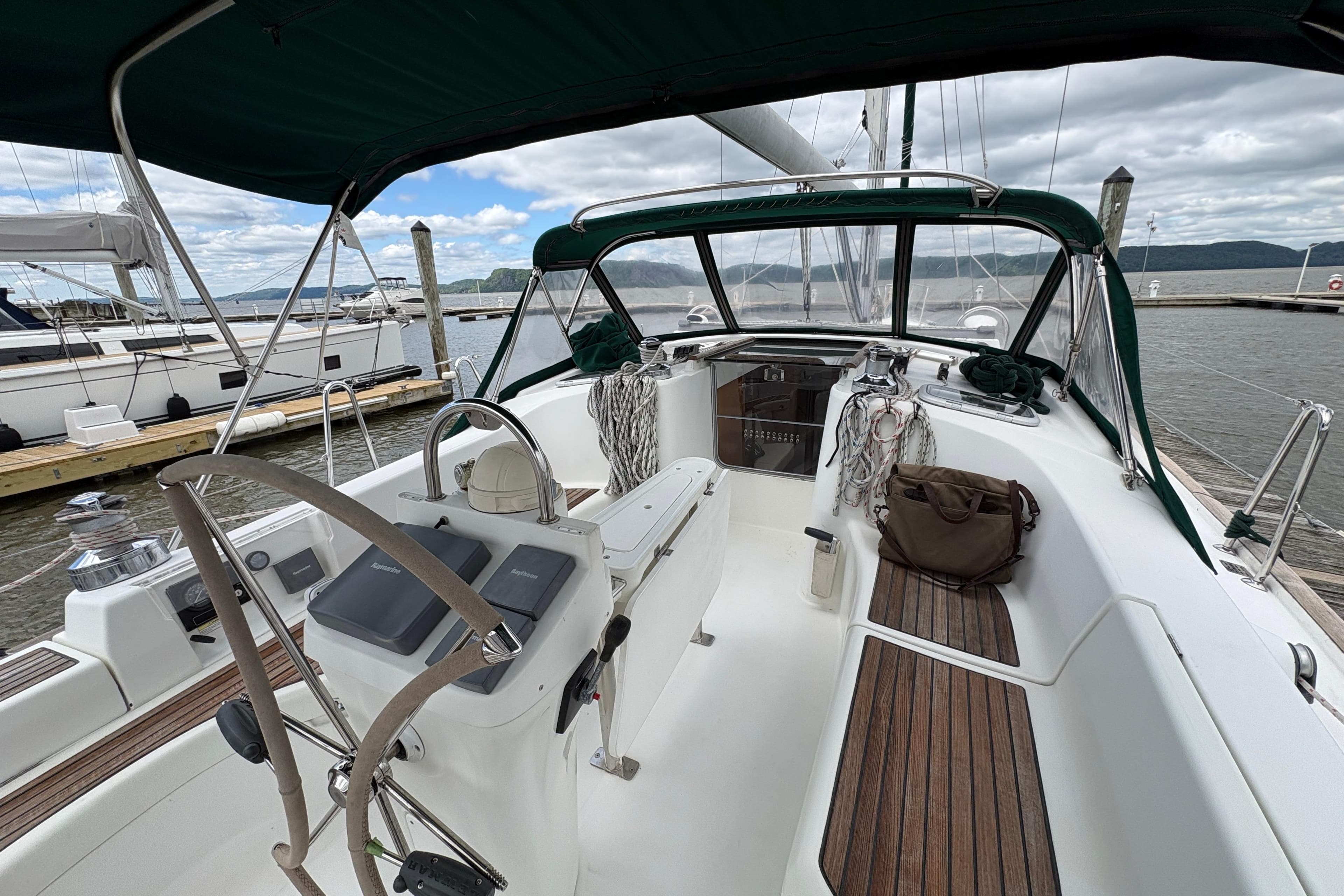 Cockpit view of a 2003 Beneteau 423 sailboat docked at a marina.