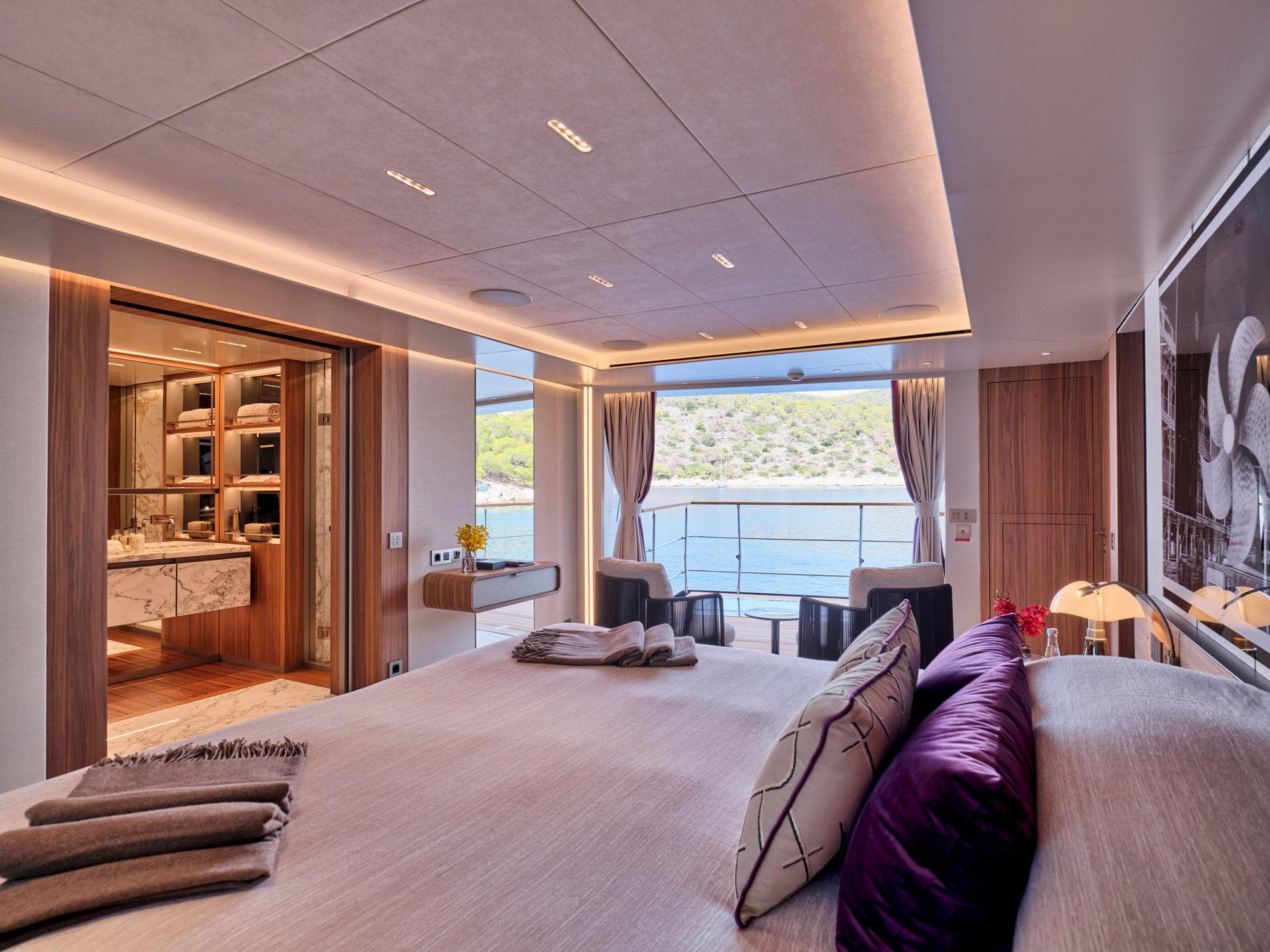Luxurious Sanlorenzo 500EXP 2023 yacht bedroom with ocean view and elegant interior design.