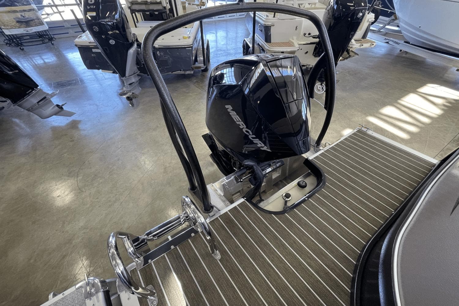 2023 Premier 250 Intrigue boat with Mercury outboard motor in showroom.
