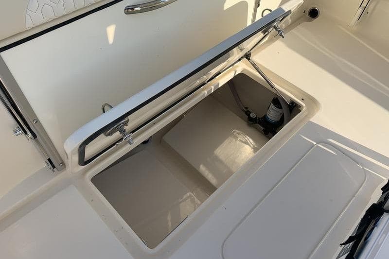2026 Scout 215 XSF boat storage compartment with open hatch, showcasing interior details.