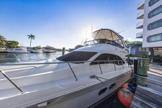 2007 Sea Ray 52 Sedan Bridge yacht docked at marina, sunny day, waterfront view.