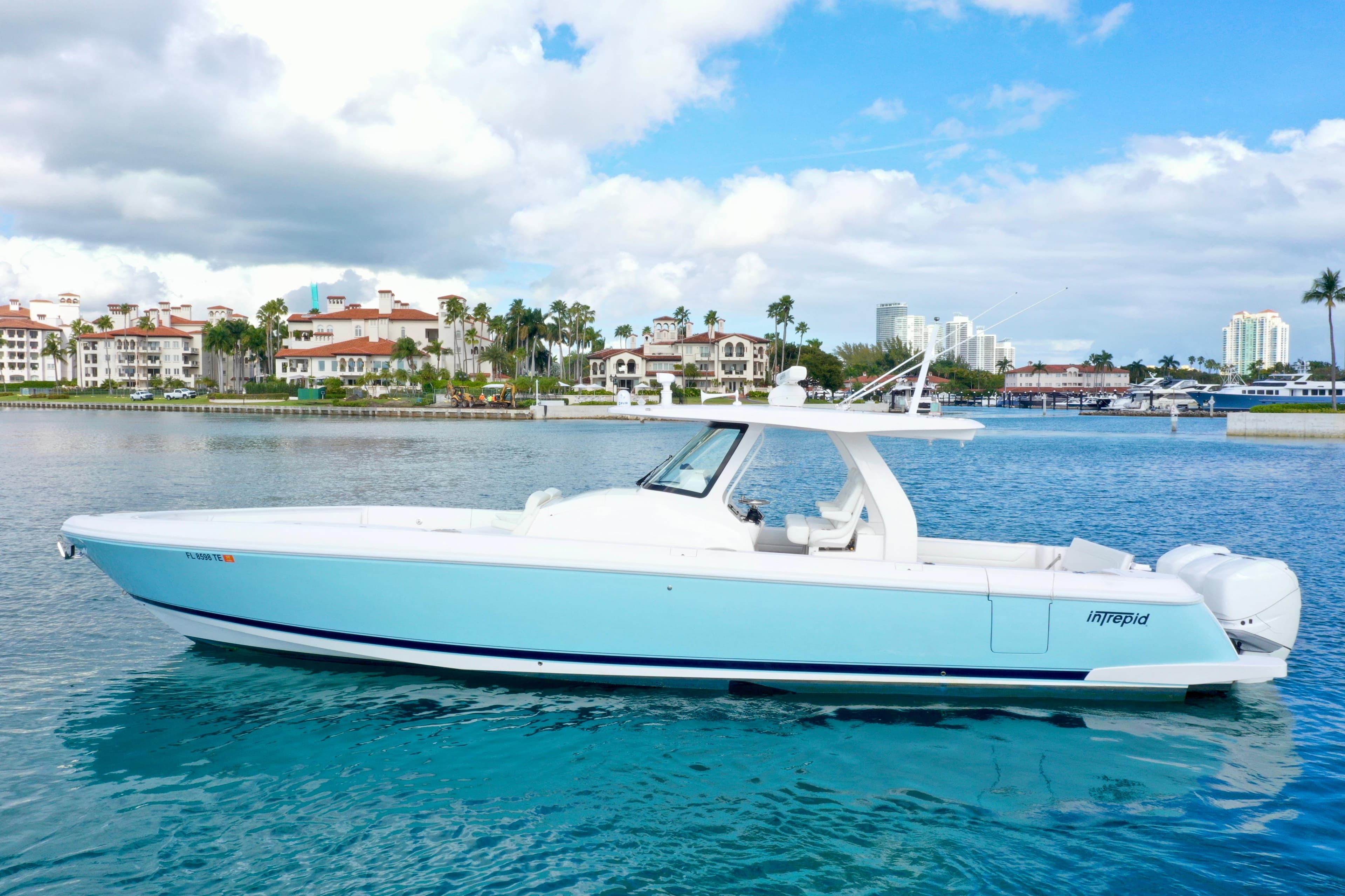 2022 Intrepid 407 Nomad SE boat on calm water with scenic coastal backdrop.