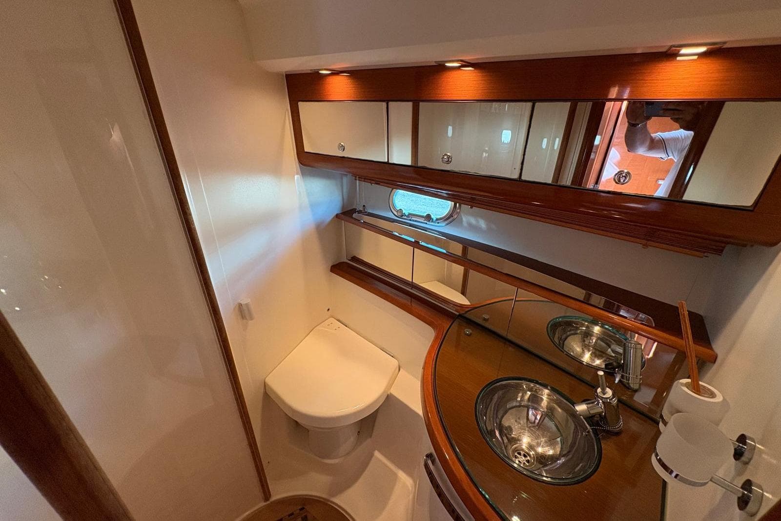 Luxurious bathroom in 2010 Jeanneau Prestige 50 yacht with modern fixtures and wood accents.