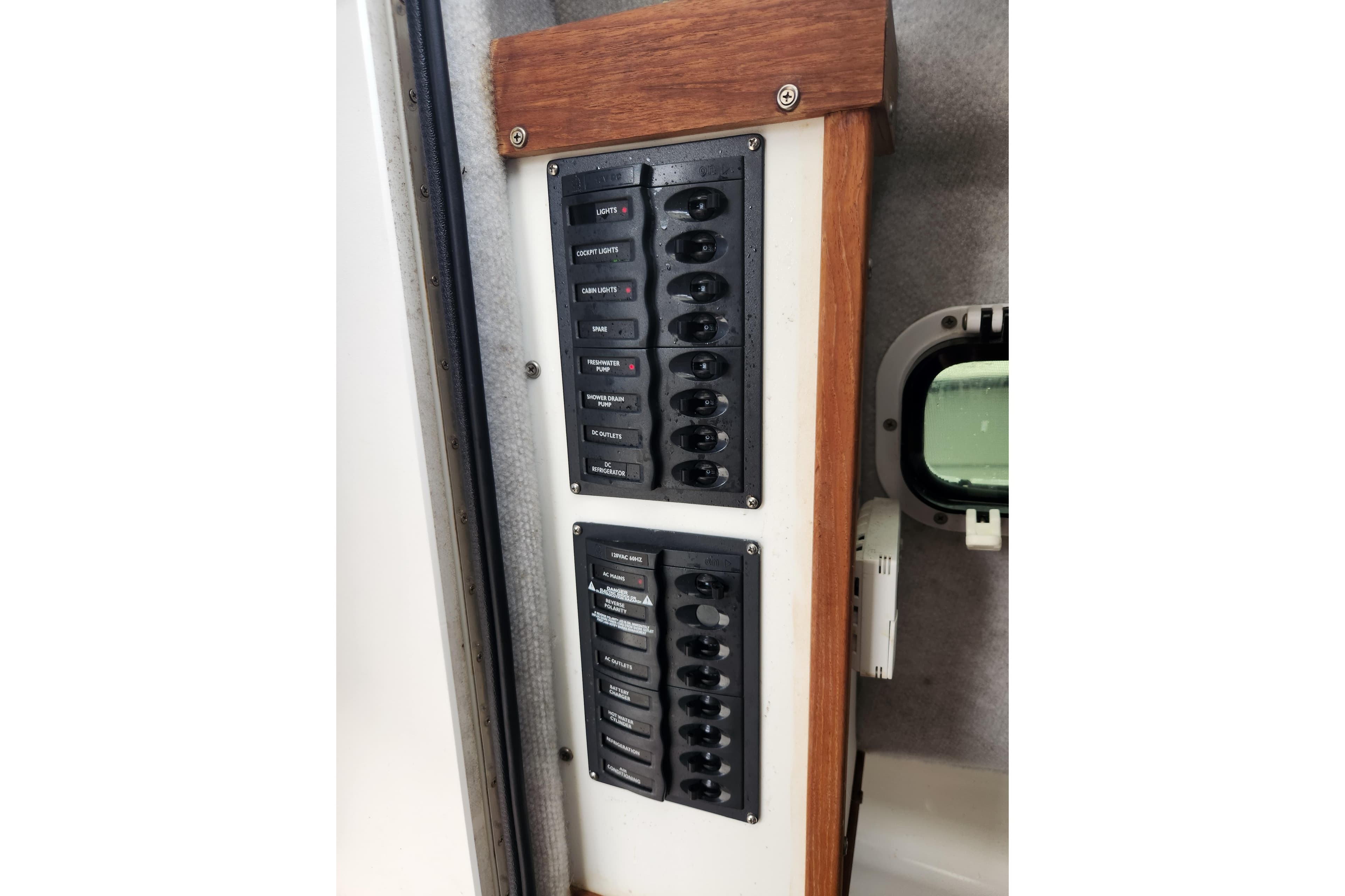 Electrical panel with labeled switches in a 2018 Atlas Acadia boat interior.