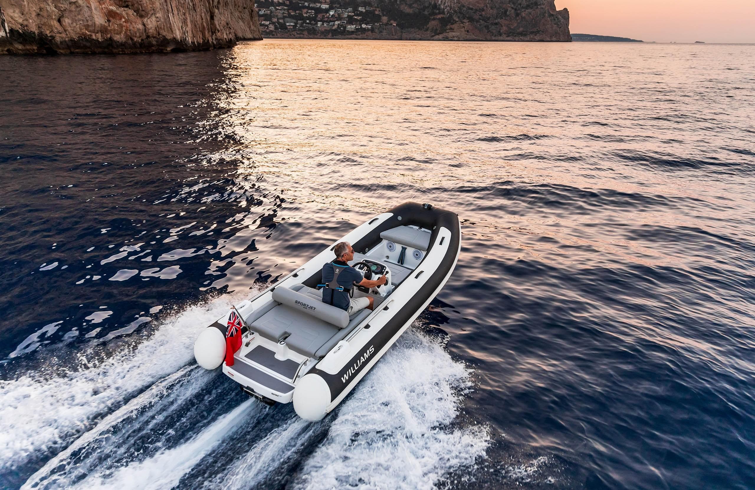 2025 Williams Jet Tenders Sportjet 435 cruising on ocean at sunset.