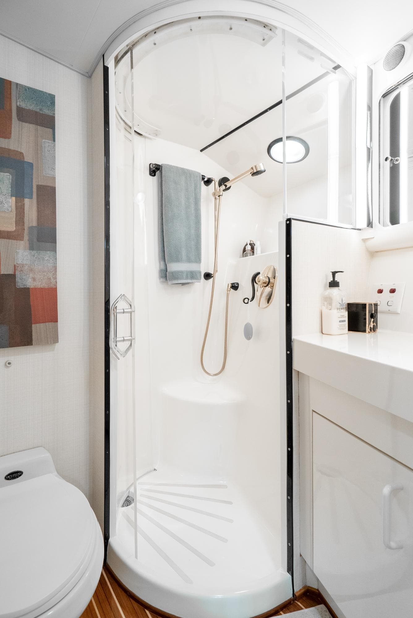 Compact bathroom with modern shower in 1990 Hatteras 58 Sportfish yacht.
