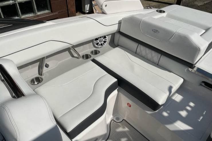 2025 Regal LS2 Surf boat interior with white leather seating and cup holders.