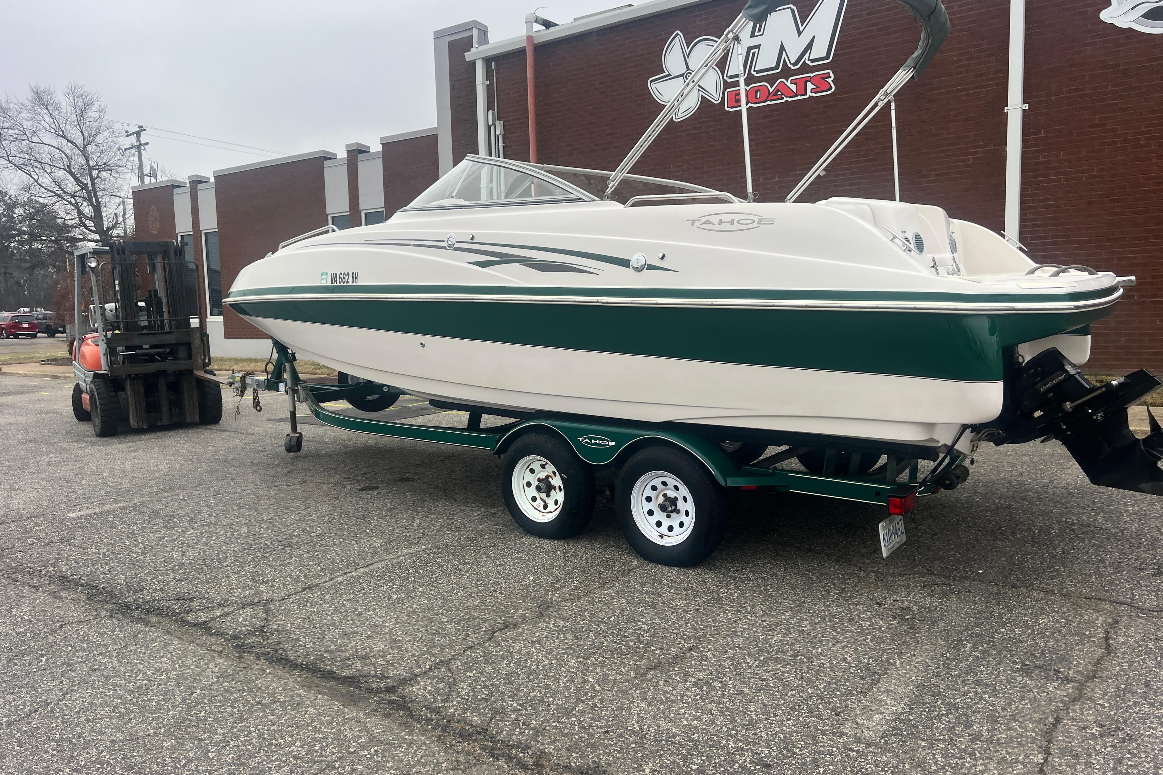 2005 Tahoe 234 boat on trailer outside HM Boats building.