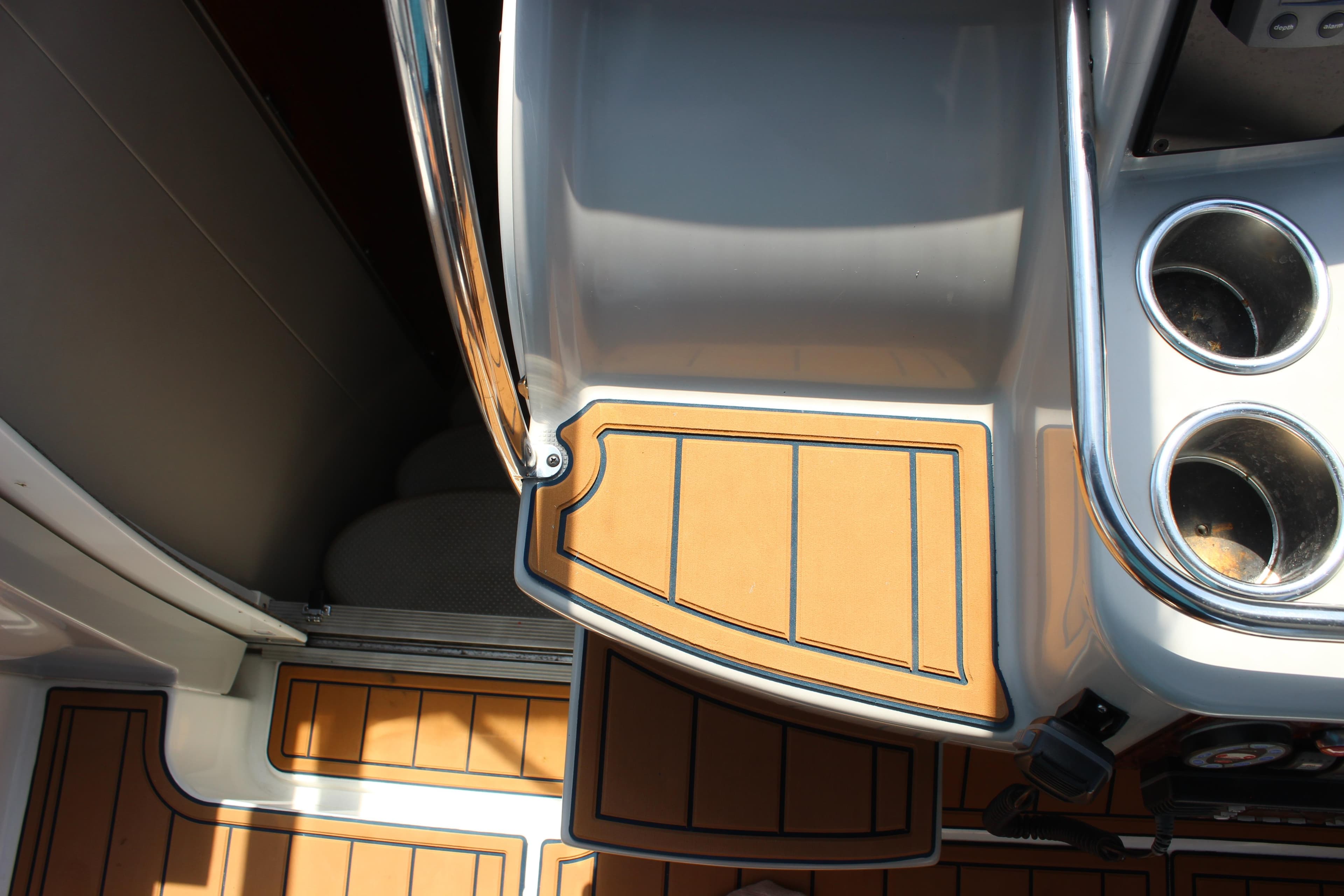 2005 Formula 31 Performance Cruiser interior with teak flooring and stainless steel cup holders.