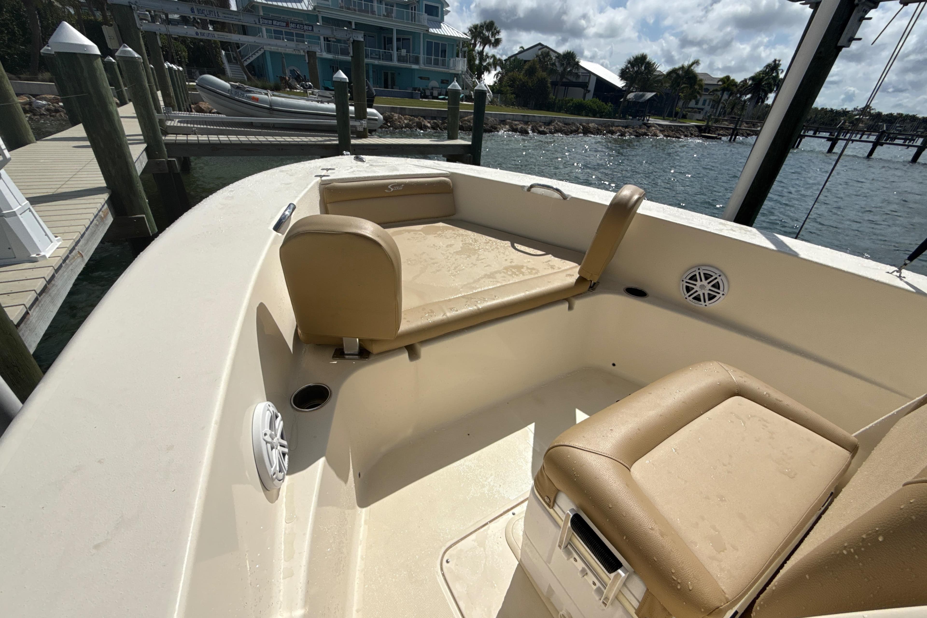 2021 Scout 195 Sportfish boat interior with beige seating at a dockside location.