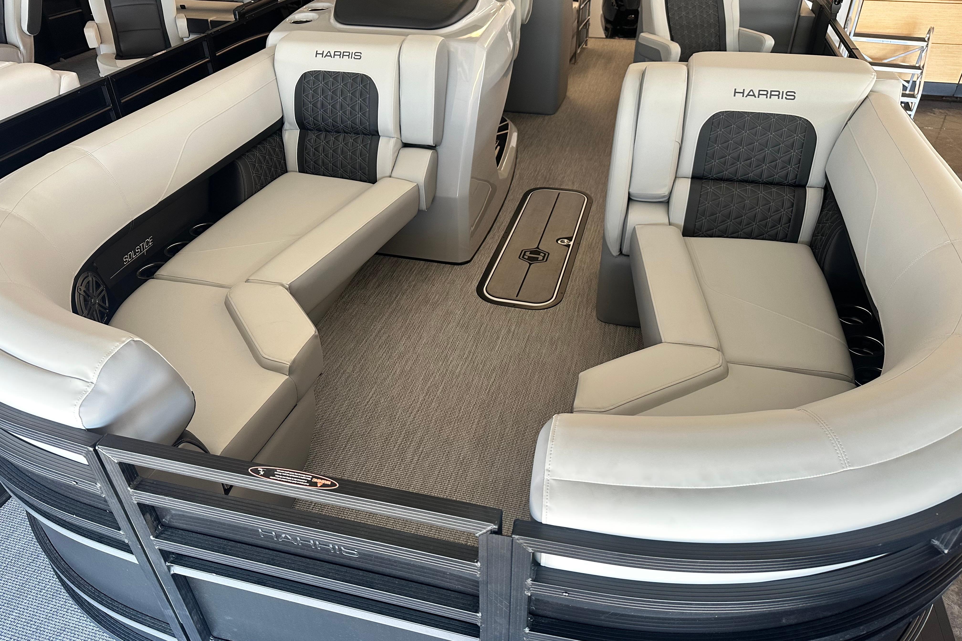 Luxurious interior of 2026 Harris Solstice 230 CWDH pontoon boat with plush seating.