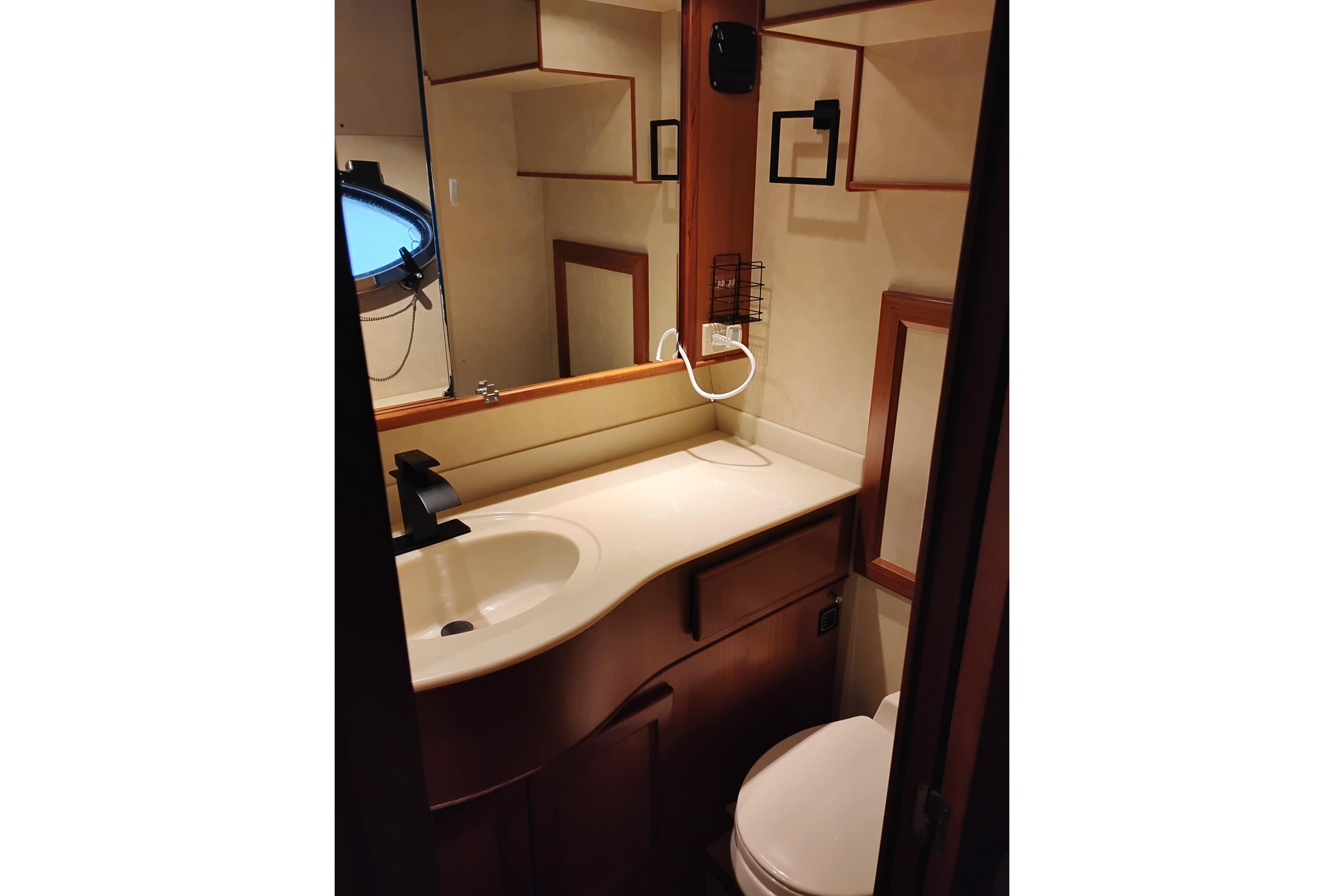 Bathroom interior of a 1997 Symbol 50 Pilothouse yacht, featuring sink and mirror.