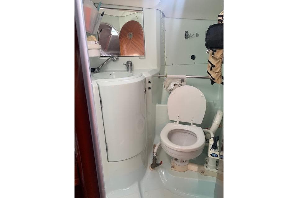 Bathroom of 1993 Beneteau First 35.7 yacht with toilet and sink.