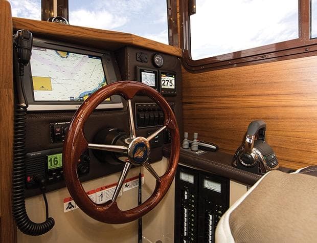 2017 Ranger Tugs R-25 SC helm with wood finish.