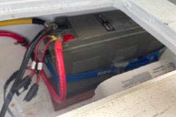 Battery compartment of a 1996 KenCraft Down East Express 35 boat with visible wiring.