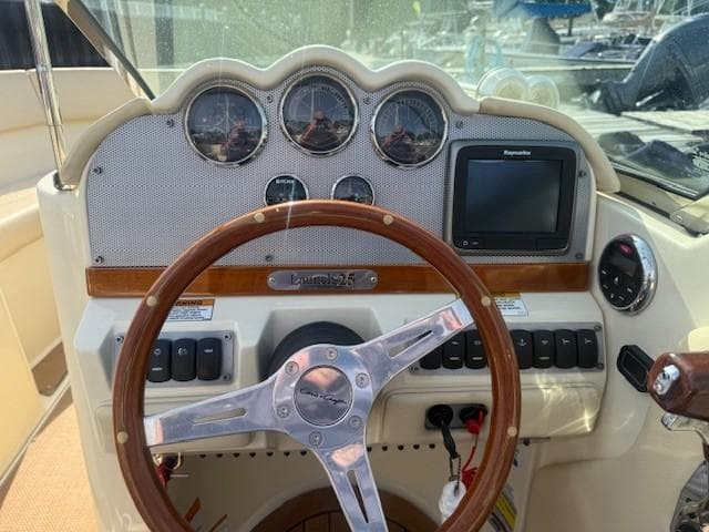 2014 Chris-Craft Launch 25 dashboard with steering wheel and gauges.
