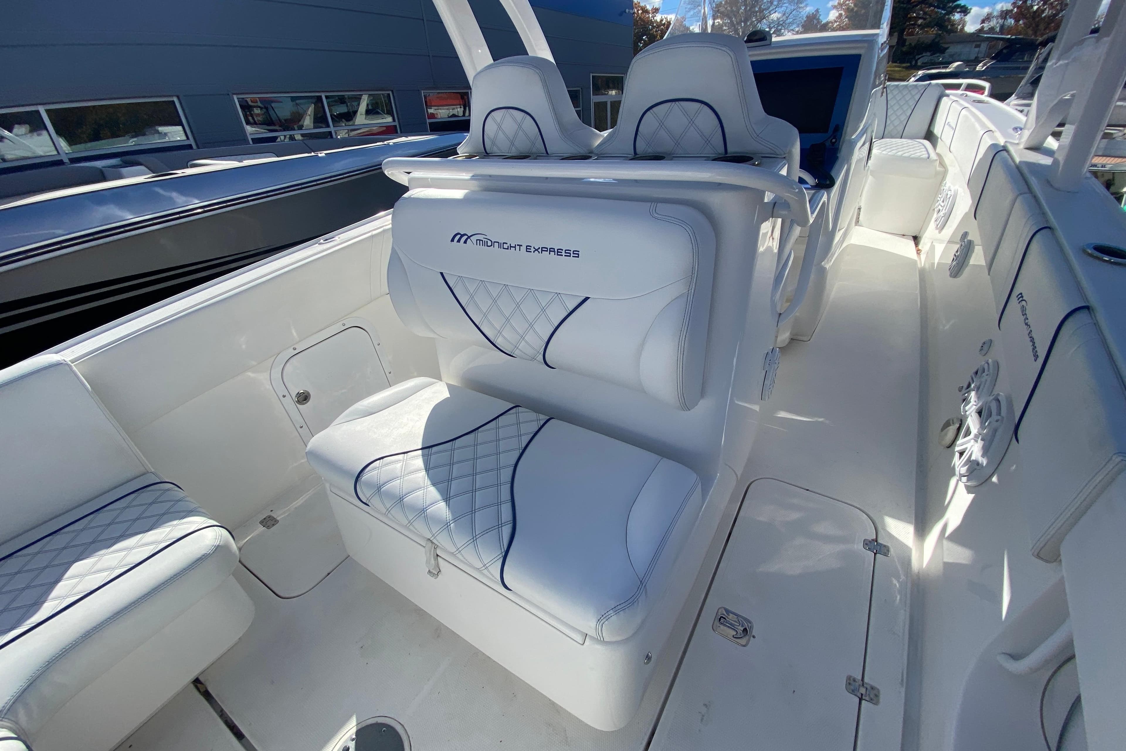 2017 Midnight Express 39S Cuddy boat interior with white cushioned seating and sleek design.