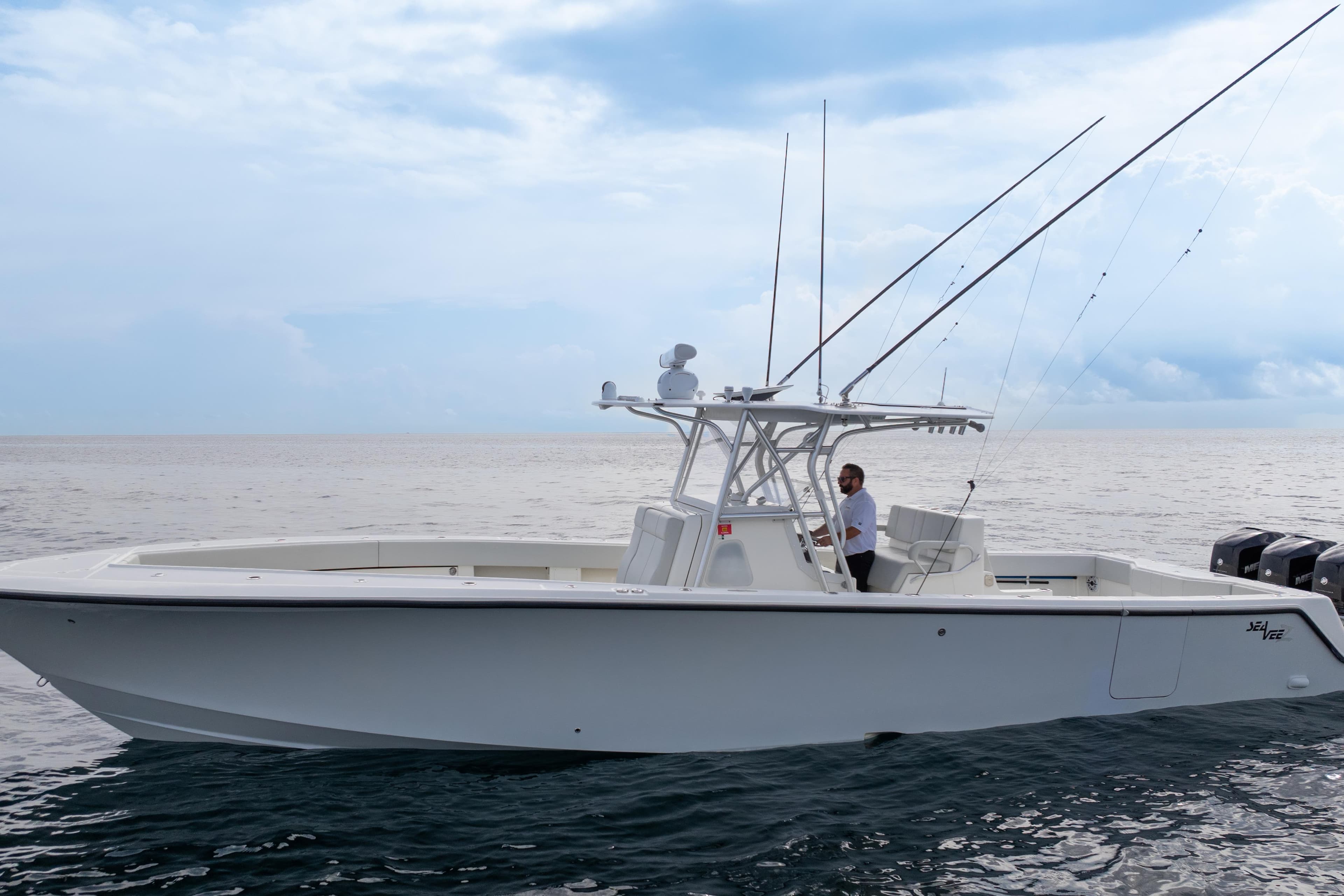 2015 SeaVee 39Z boat on open water, featuring fishing rods and a center console.