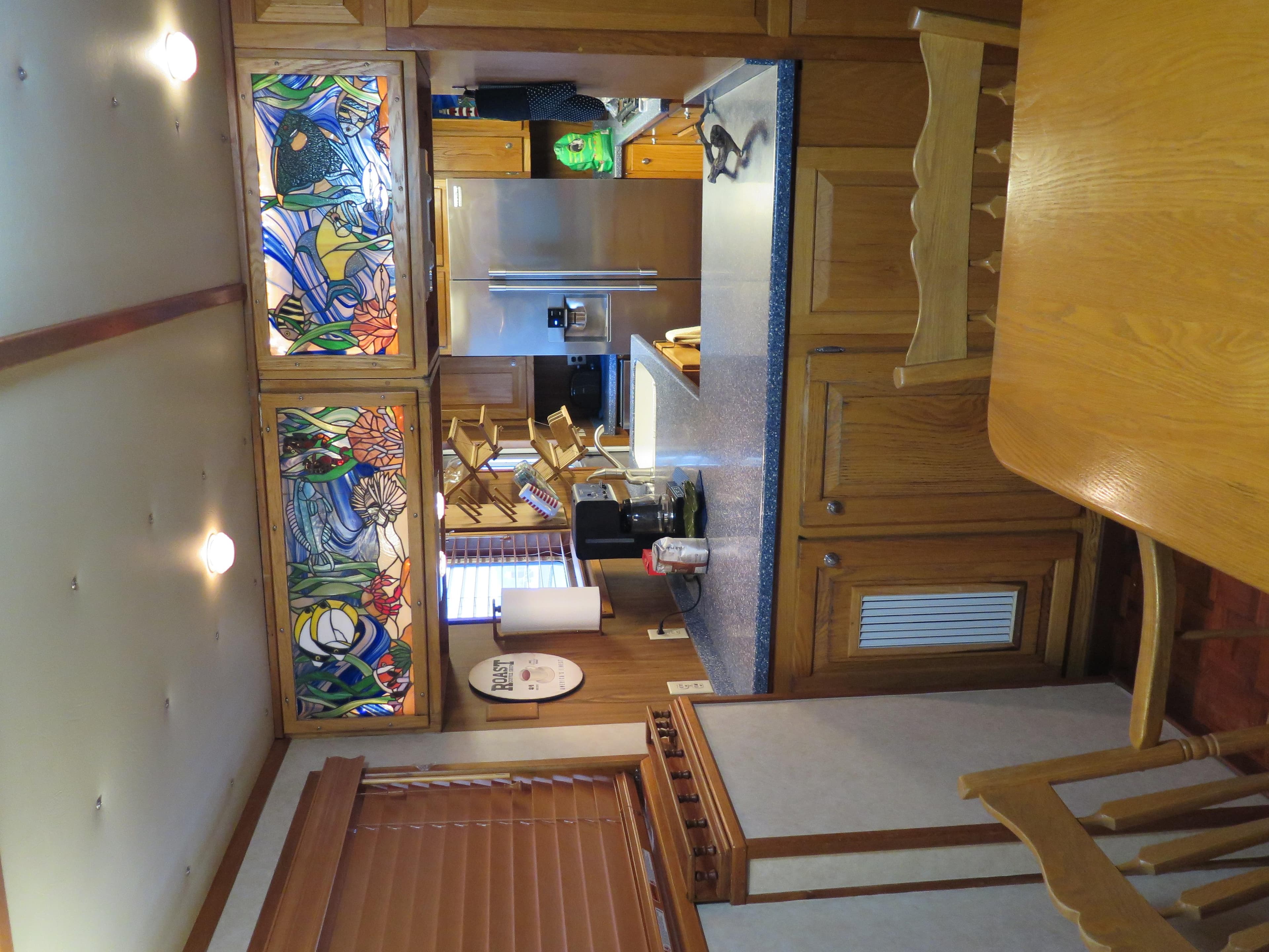 1998 Rodriquez Custom kitchen with stained glass cabinets and wooden furniture.