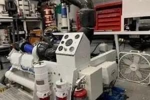 Engine room of 1997 Broward raised pilot house M/Y with machinery and tools.