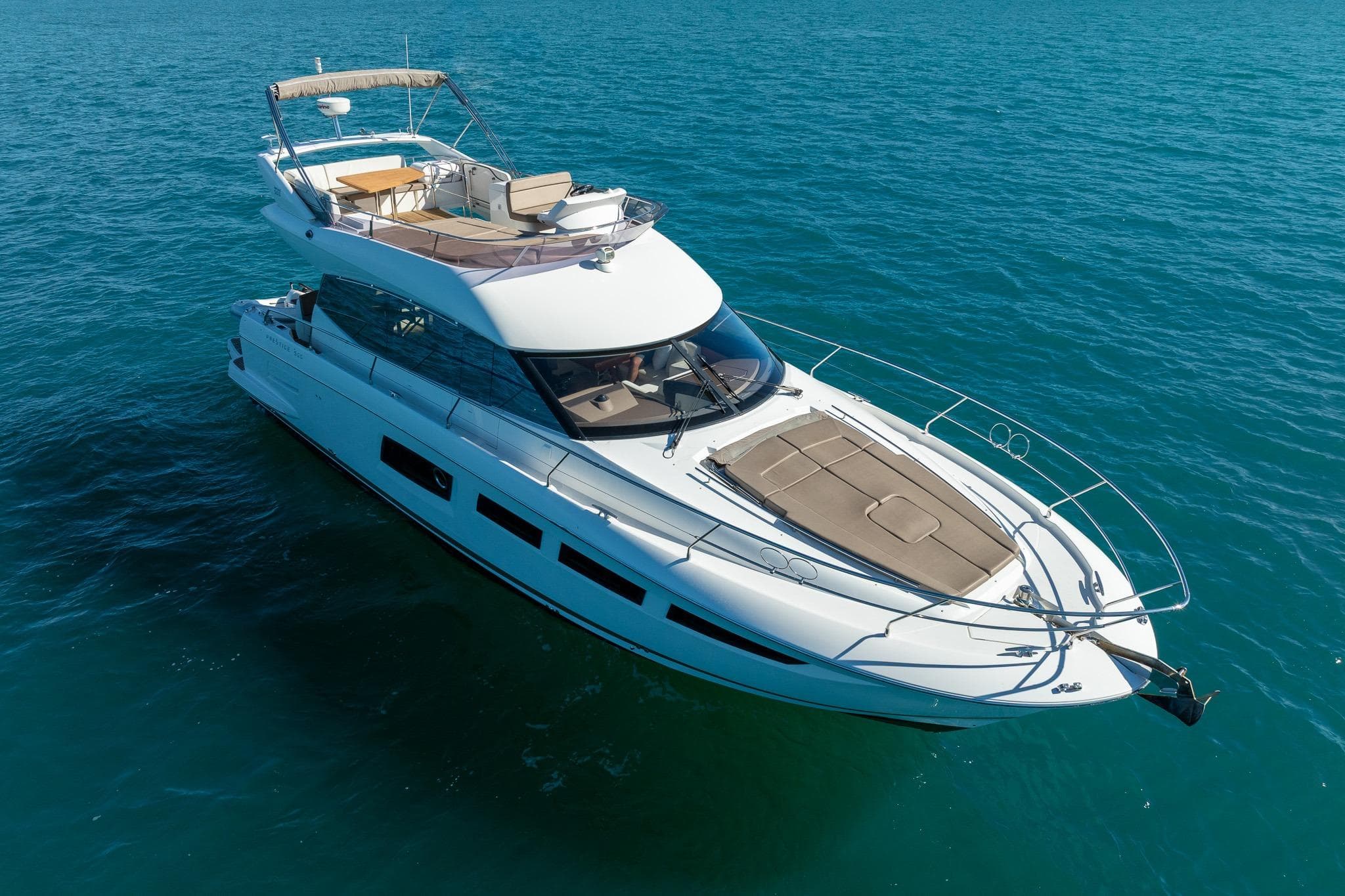 2017 Prestige 500 yacht cruising on clear blue ocean waters.