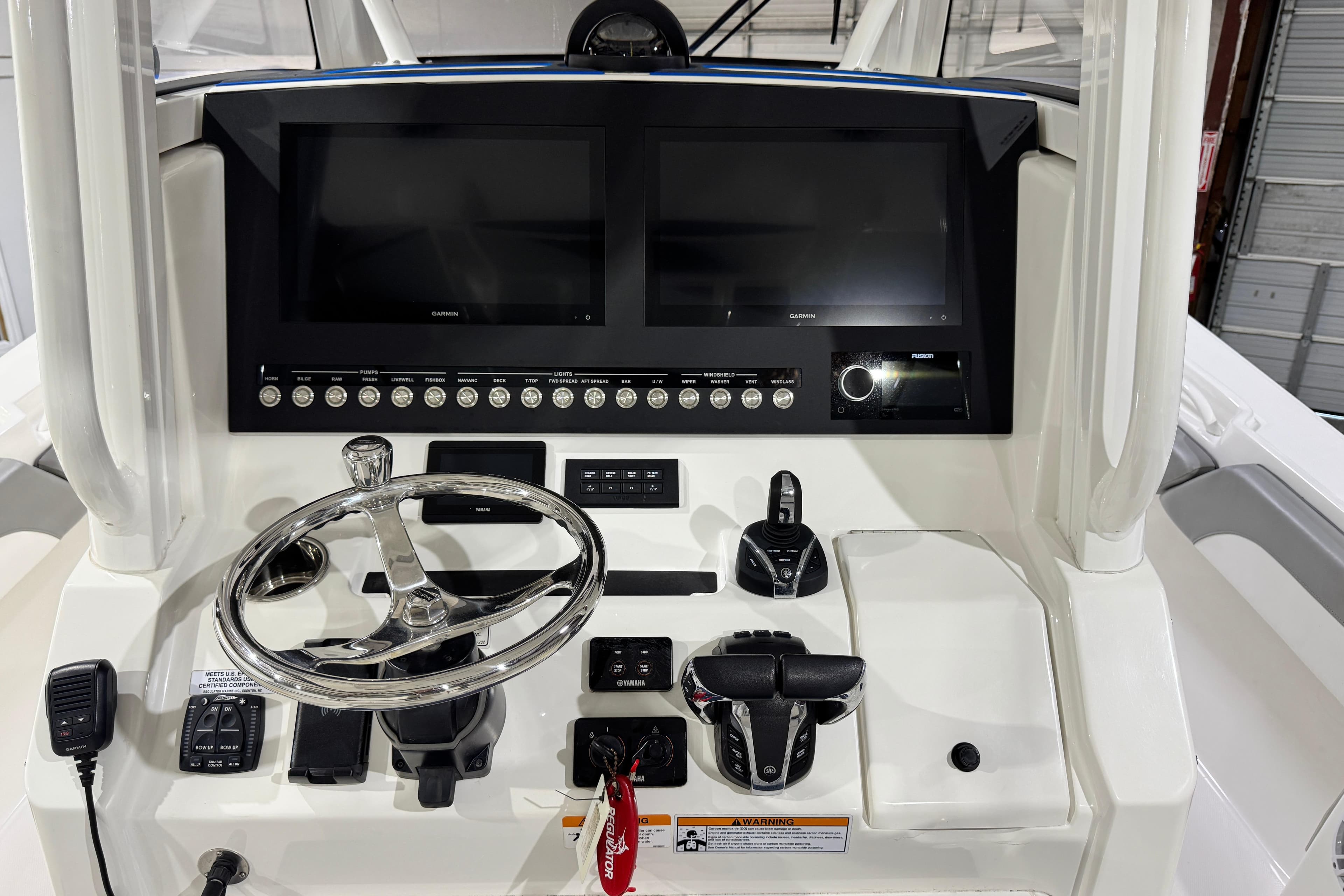 2023 Regulator 28 boat dashboard with dual screens and steering wheel.