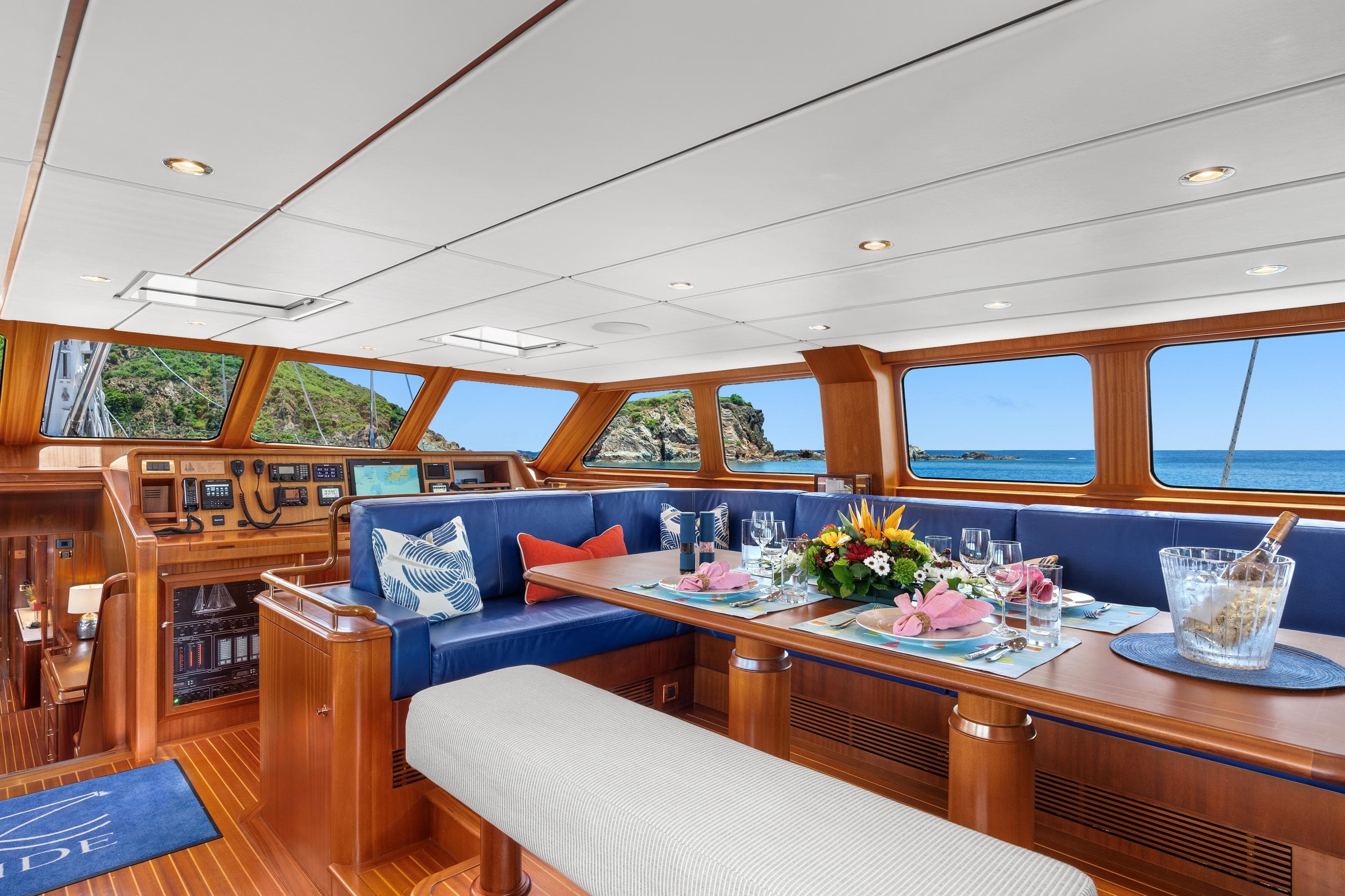 Luxurious interior of 2002 Jongert 40T yacht with elegant dining setup and ocean view.