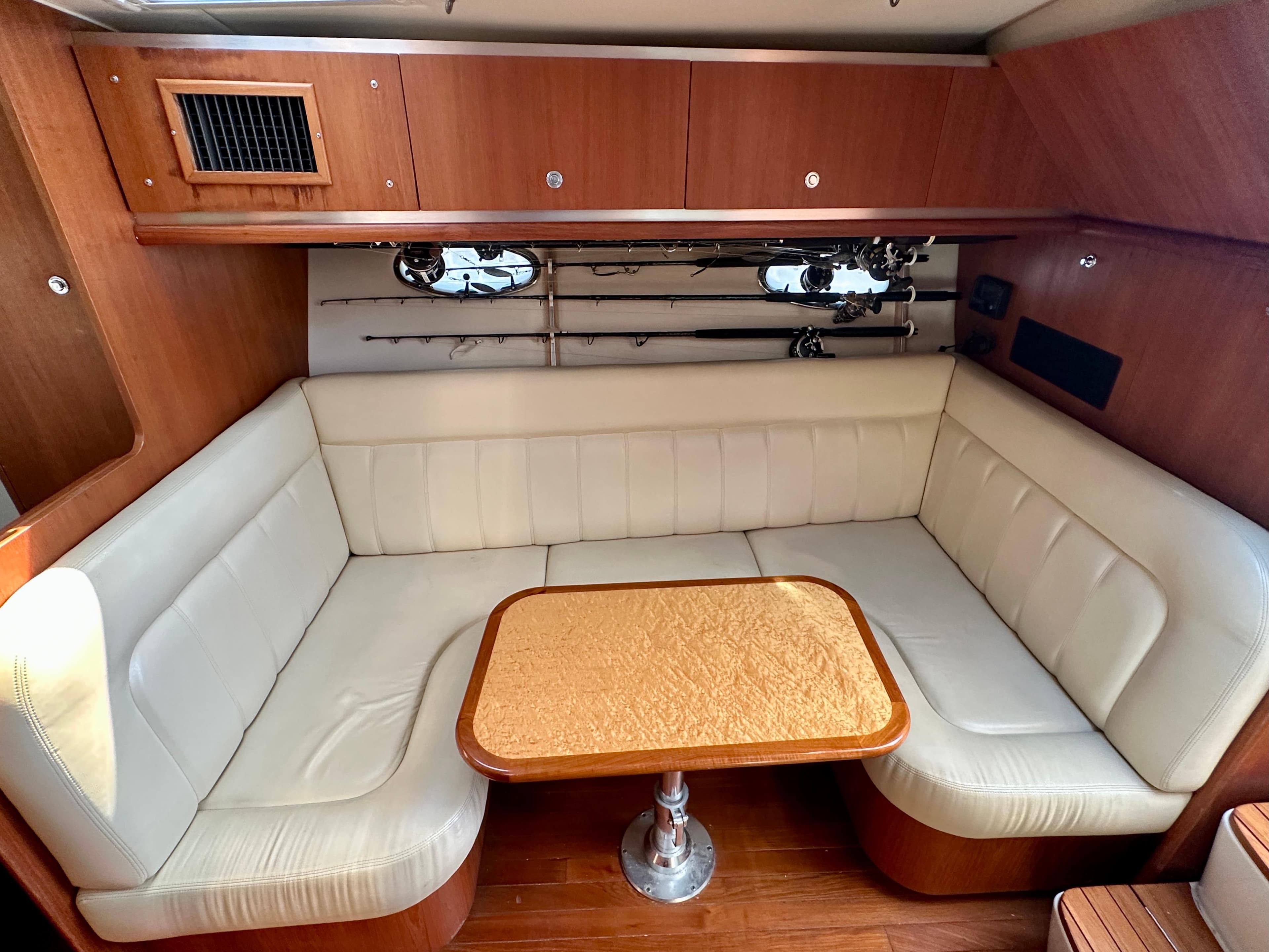 2005 Tiara Yachts 3600 Open interior with cream seating and wooden table.