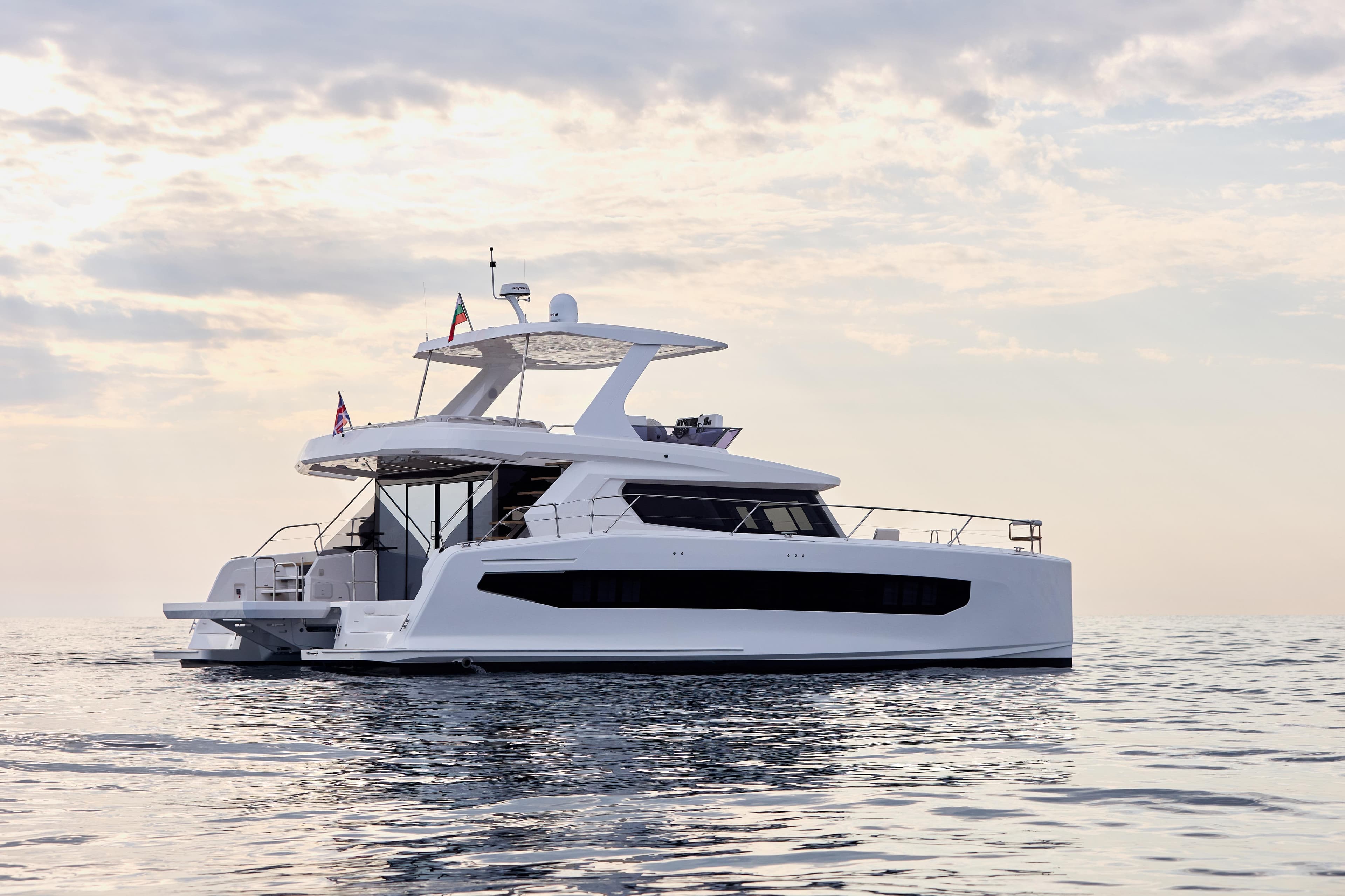 2025 Custom Omaya 50 Catamaran on calm sea under cloudy sky.