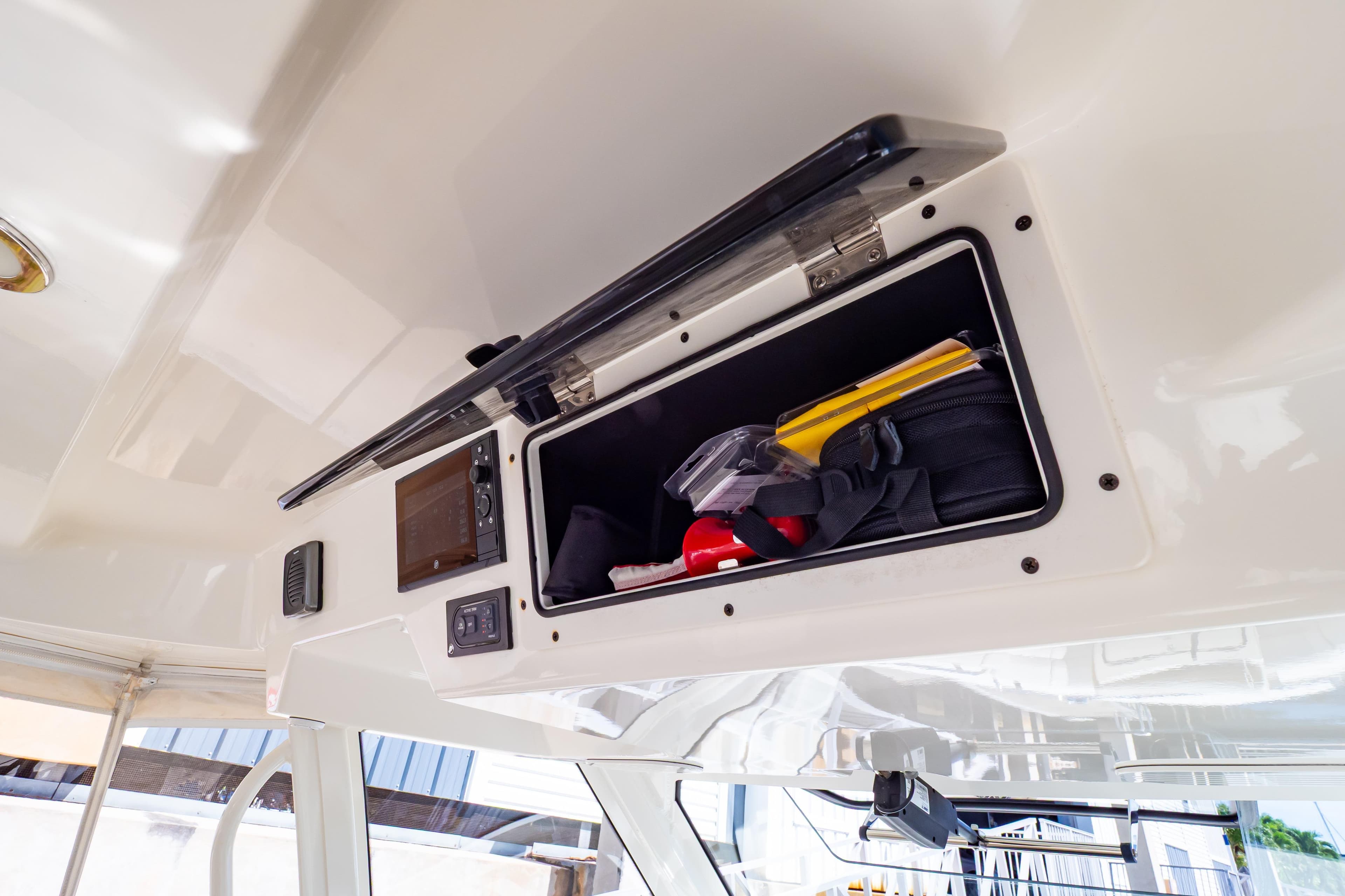 Storage compartment on a 2019 Boston Whaler 350 Realm boat, containing safety equipment.