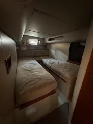 2001 Cruisers Yachts 3870 Express cabin with twin beds and small window.