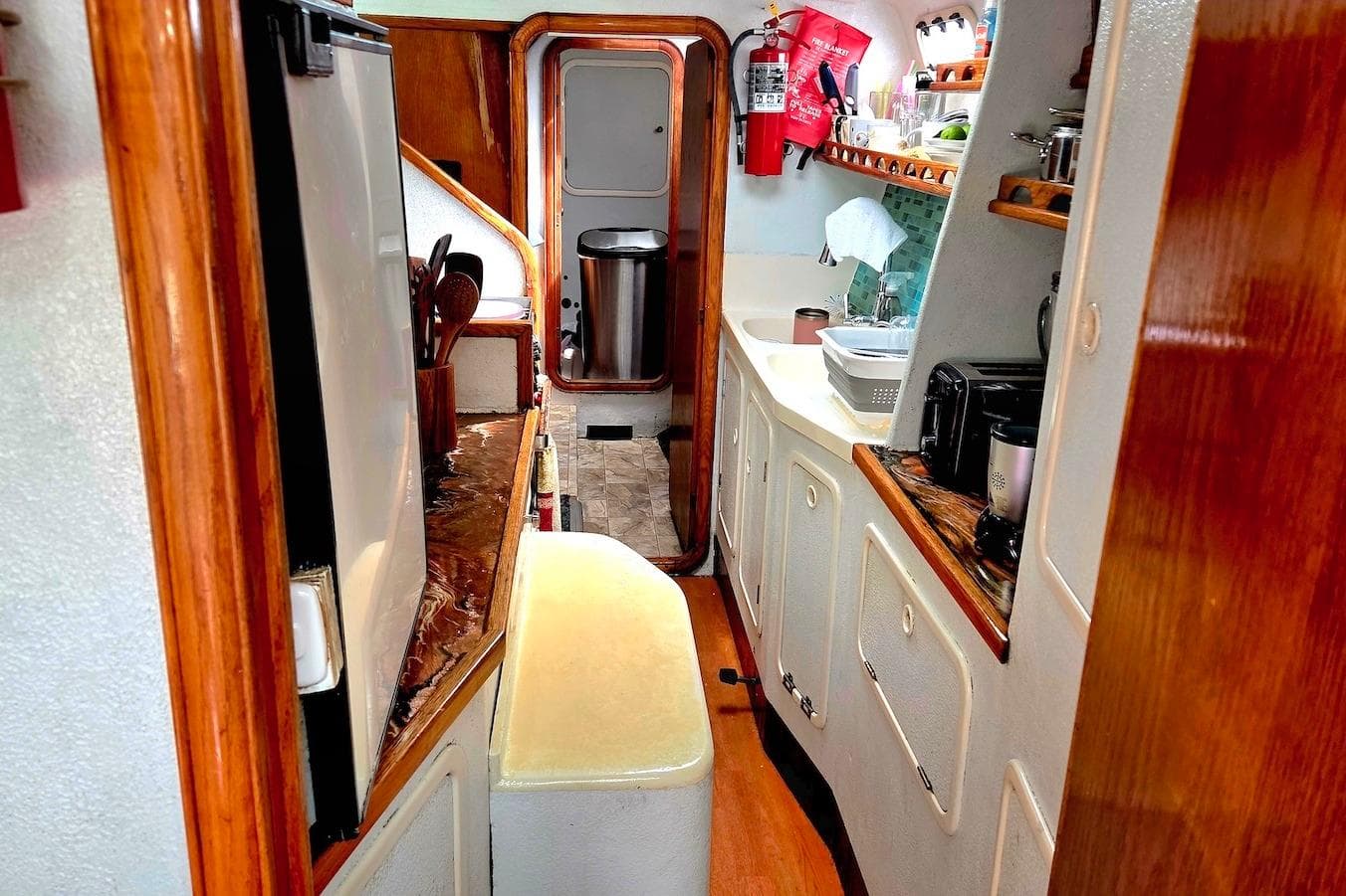 Interior of 1995 Catamaran St. Francis 43, featuring a compact kitchen area.
