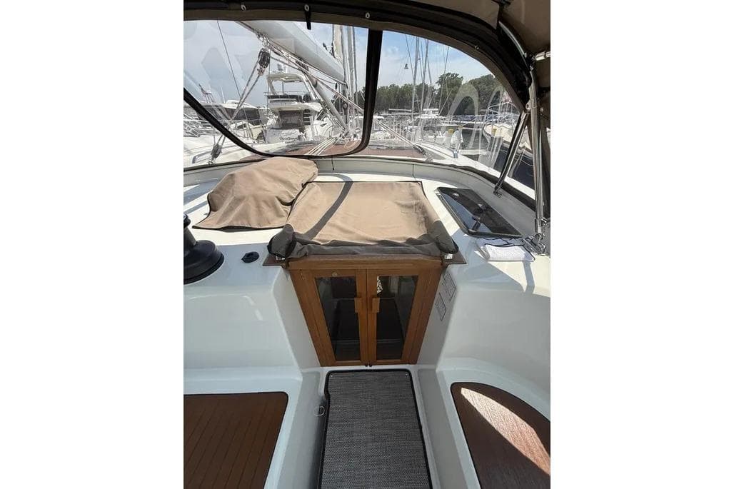 Cockpit view of 2016 Bavaria Vision 46 sailboat, featuring covered seating and wooden accents.