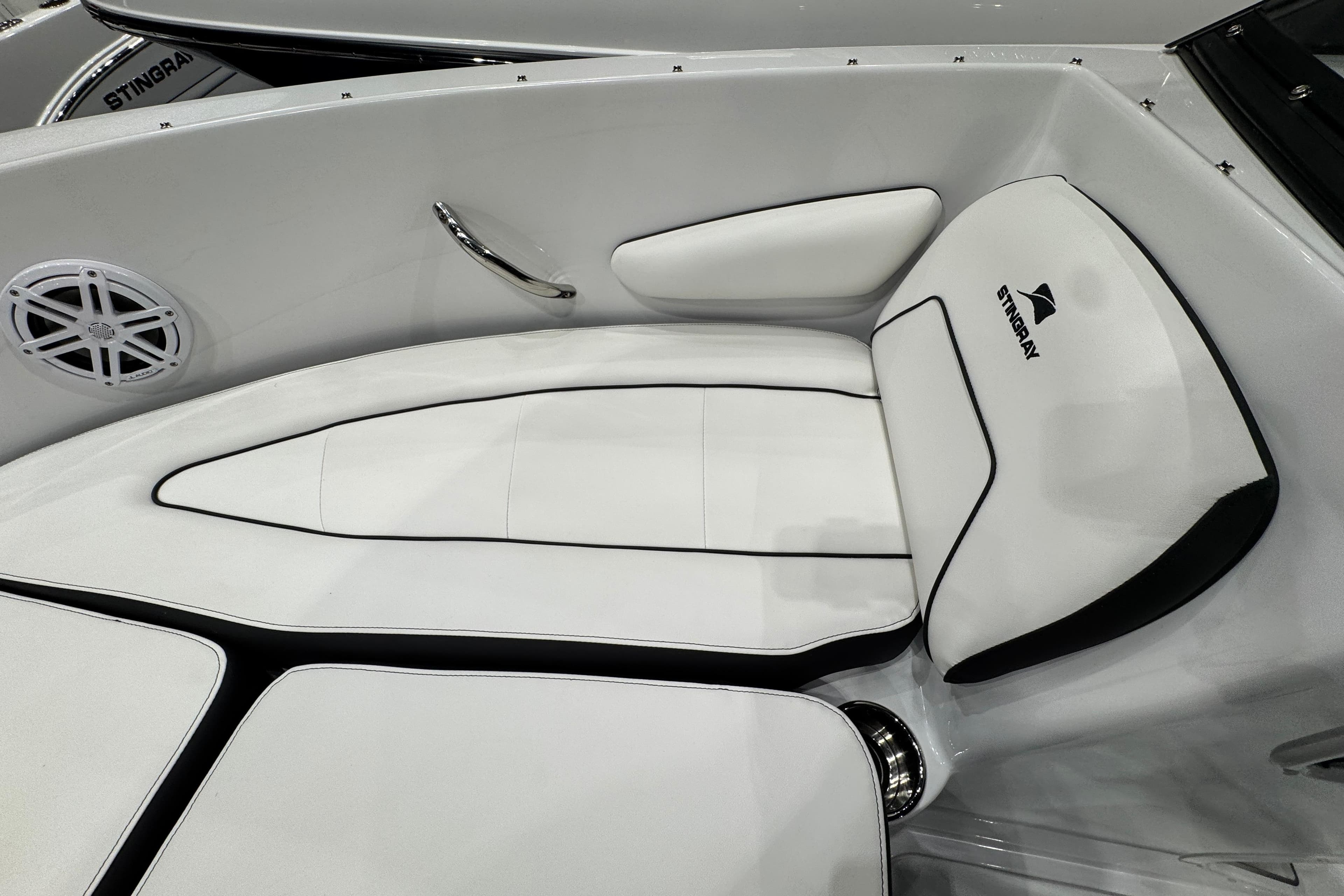 Interior of 2026 Stingray 172 DC boat with white cushioned seating and speaker.