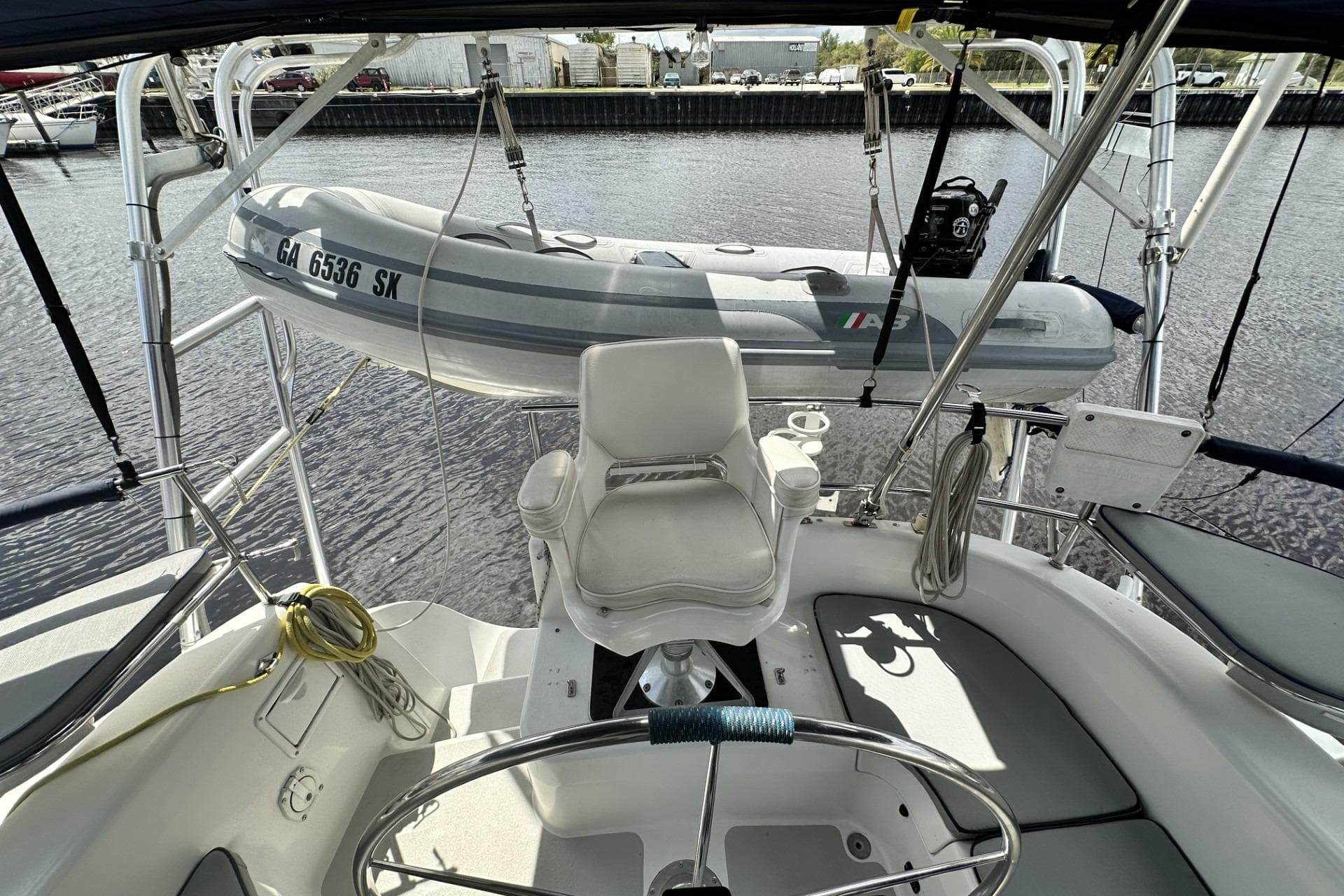 Cockpit view of 2005 Catalina Morgan 440 sailboat with dinghy on davits.