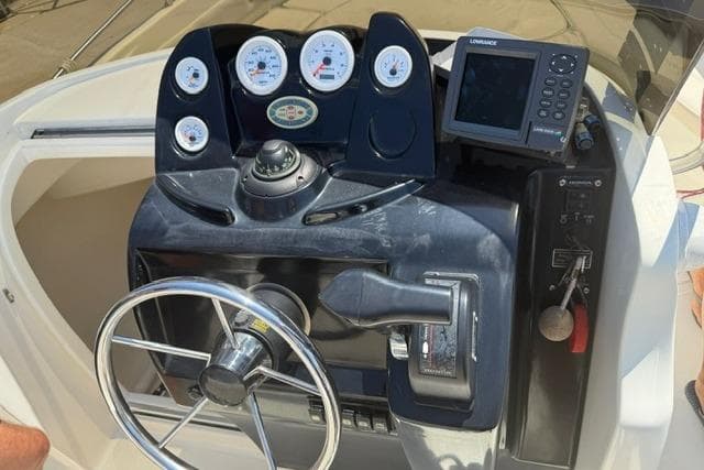2008 Ocean Craft 640 WA boat dashboard with steering wheel and navigation instruments.